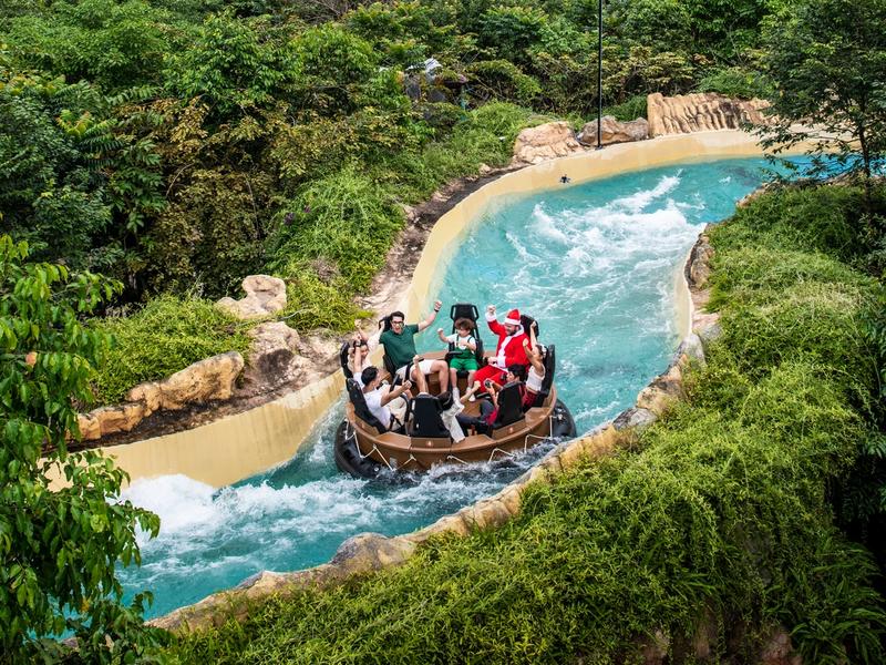 Visitors in a circular raft on a landscaped water channel