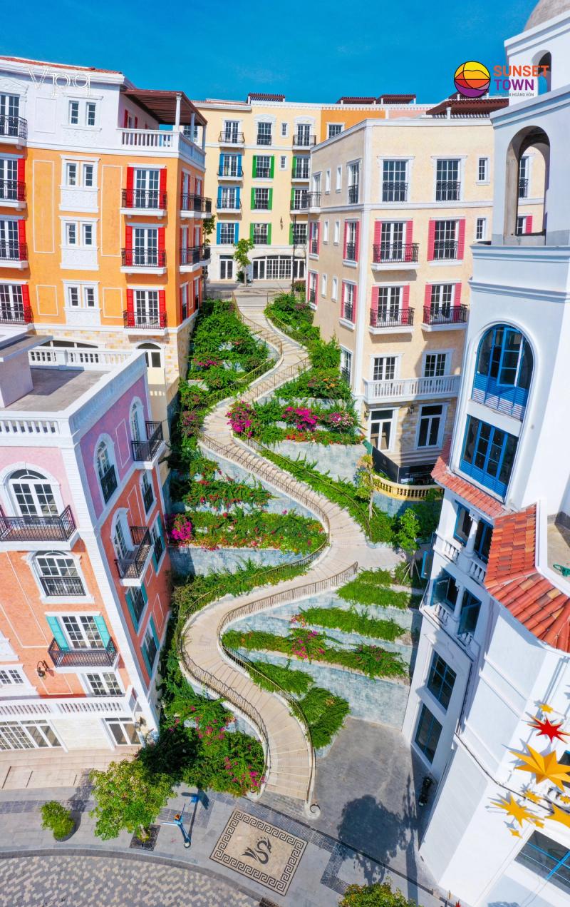 A winding garden path between Sunset Town buildings. Check the actual entrance and route with your accommodation.