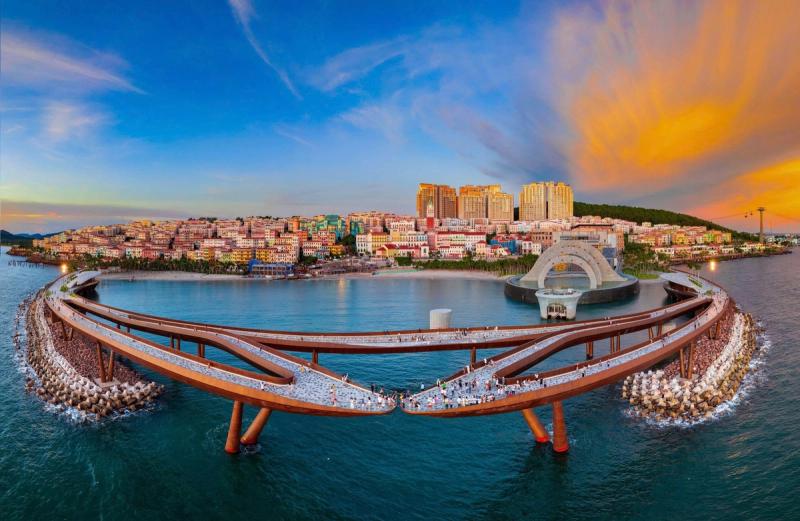 Kiss Bridge and Sunset Town’s sea-facing performance setting, viewed together from above.