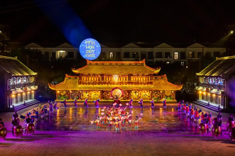Quintessence of Vietnam performers on an illuminated courtyard stage