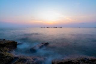 Waves washing over rocks at dusk