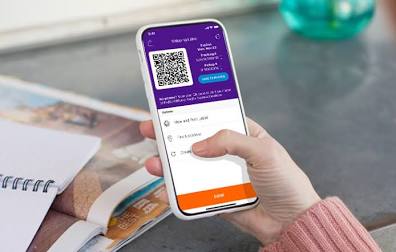 A person using a smartphone to check their FedEx package tracking status.