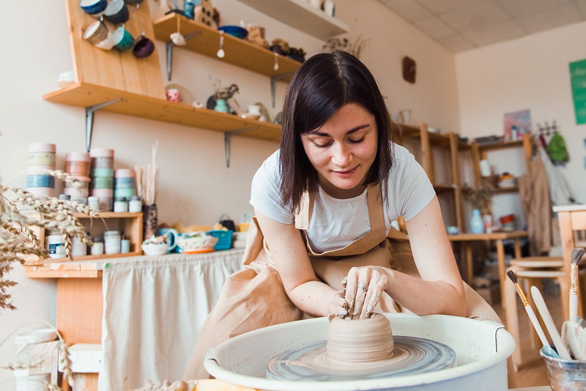 Woman molding clay