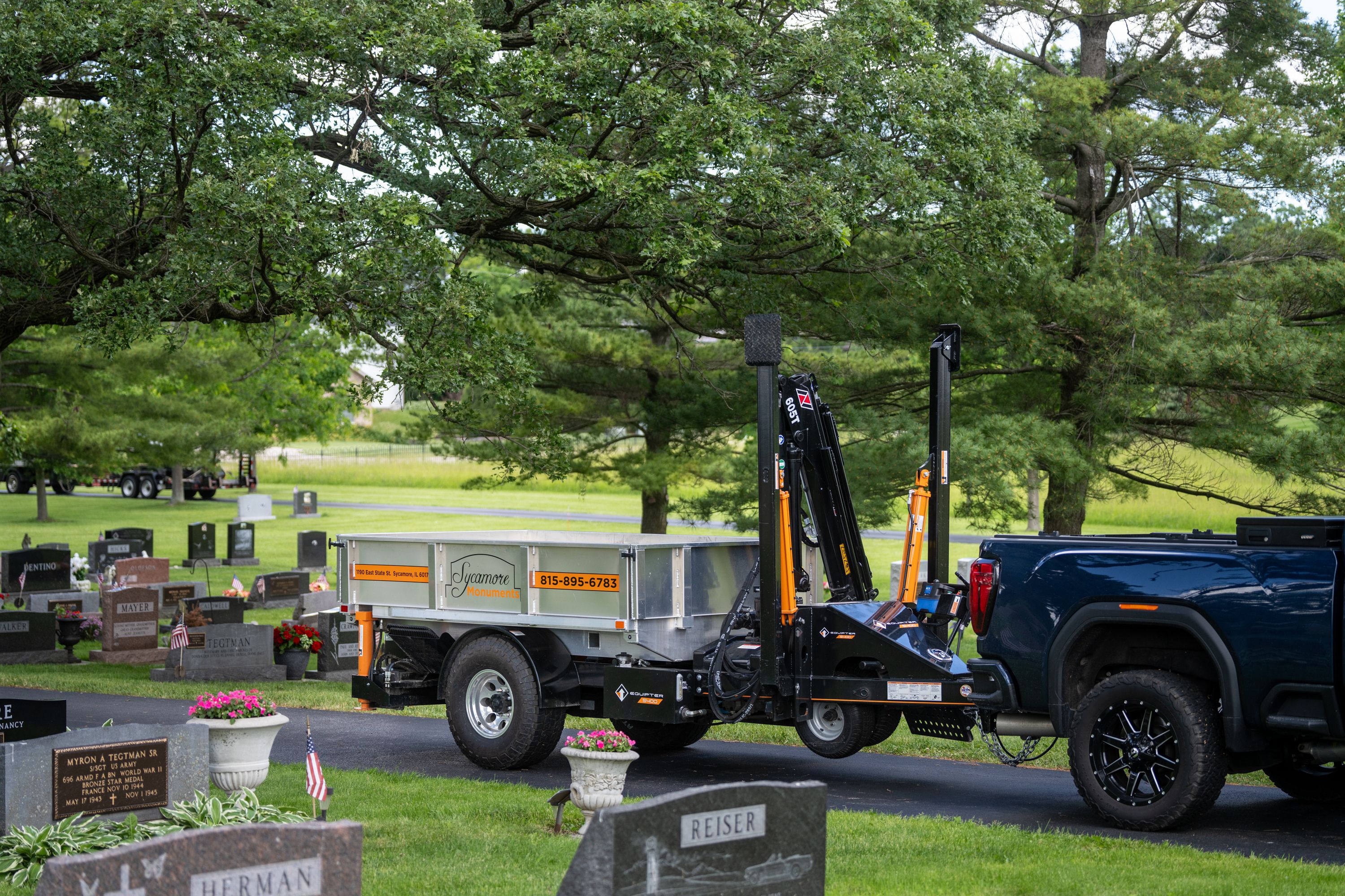 Equipter 5400 towed behind a pickup on a narrow road