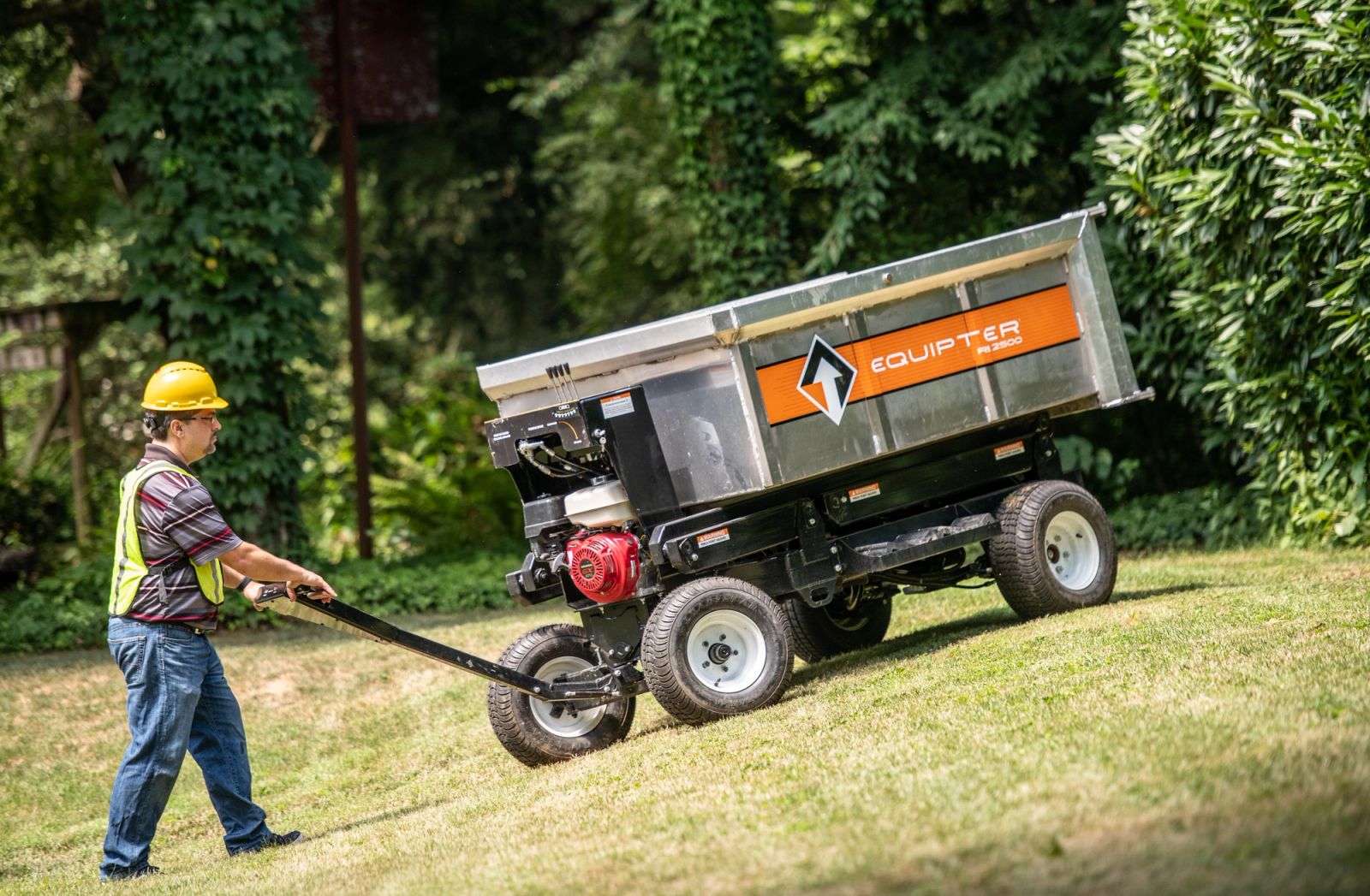 Operator driving an Equipter 2500 across a sloped lawn