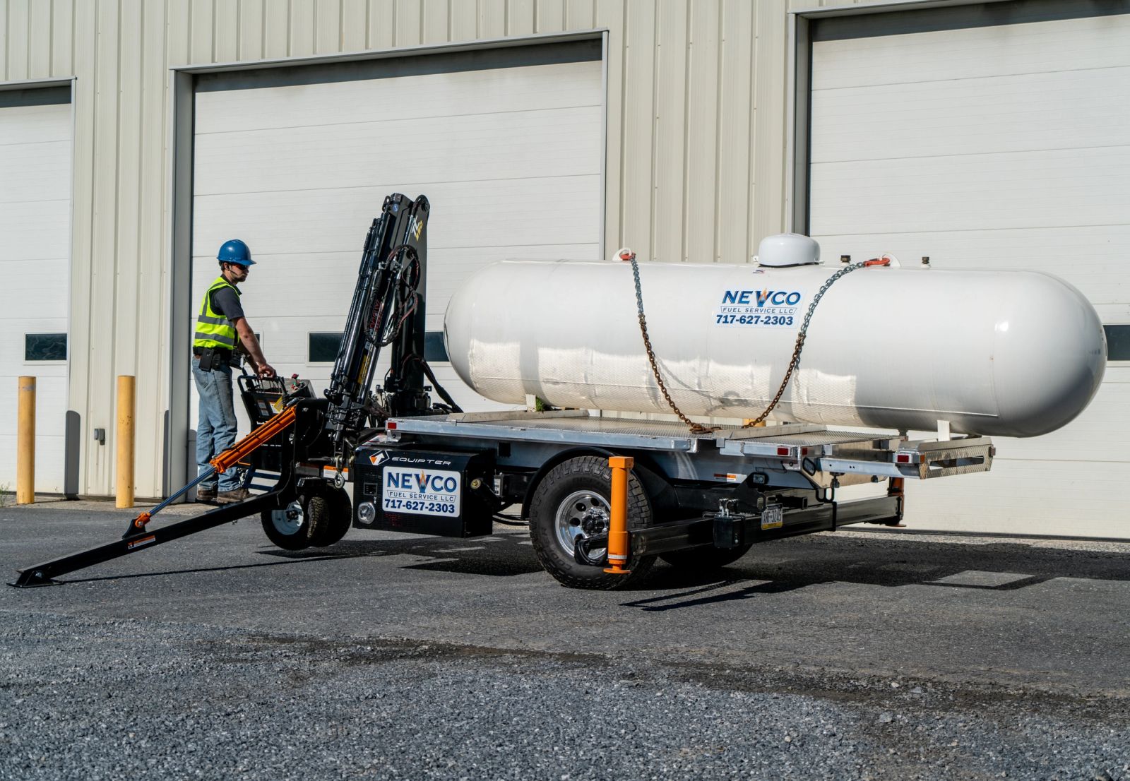 Equipter 5400 with outriggers set while the operator works the crane