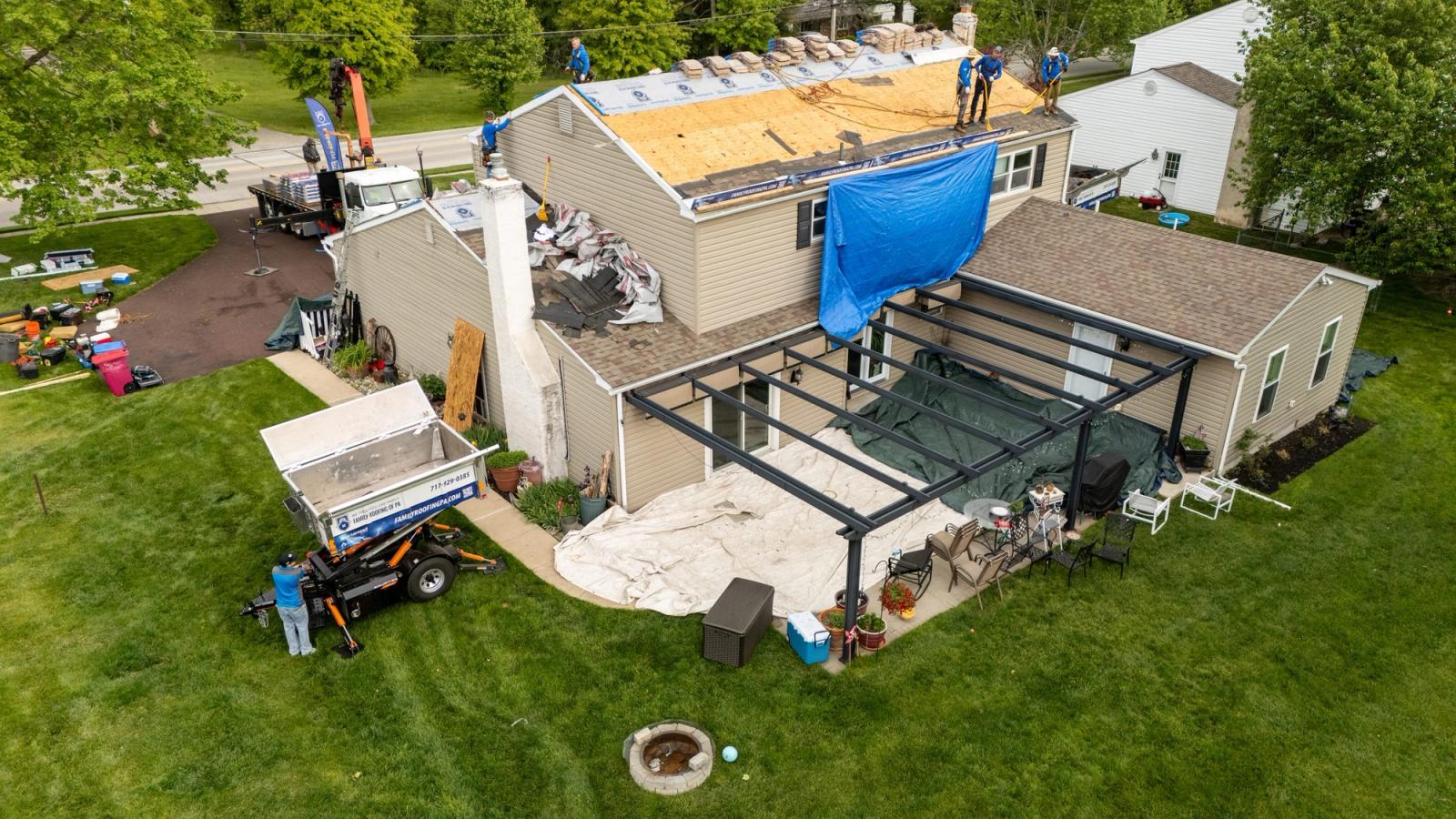 Aerial view of an Equipter 4000 raised to the rear roofline with the patio and landscaping protected below.