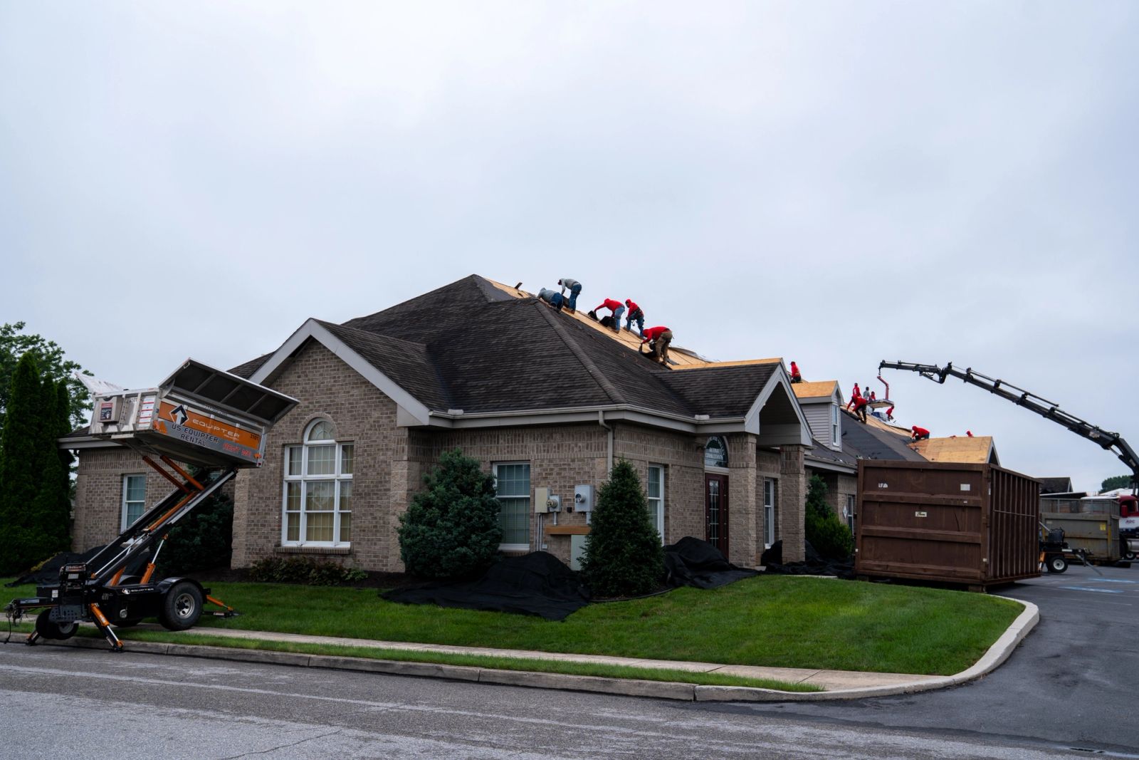 Equipter 4000 at the house while a boom truck stocks the roof on the same re-roof