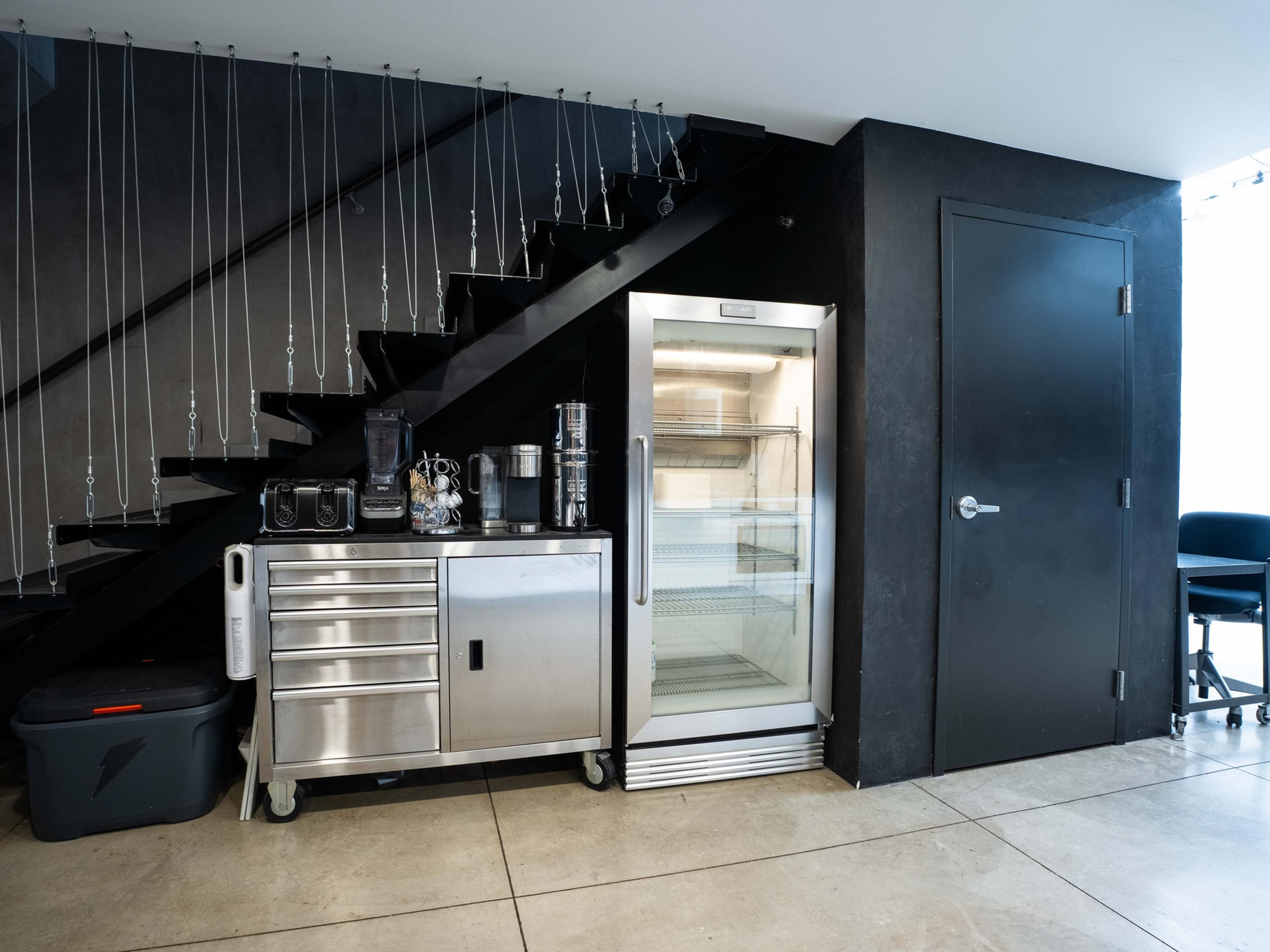 Back of house: the stair, coffee station and cold storage
