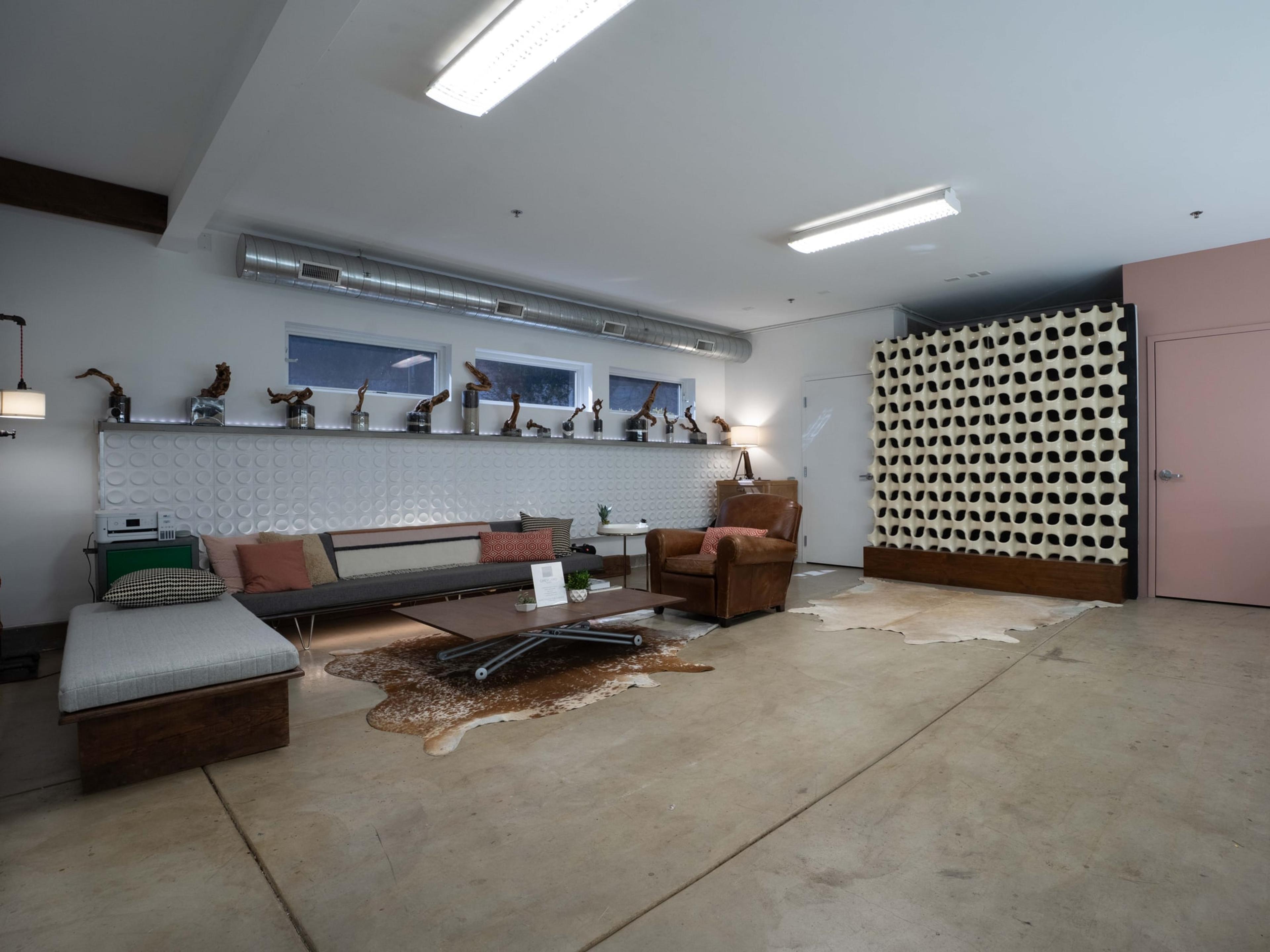 Second lounge area with a patterned accent wall and leather seating