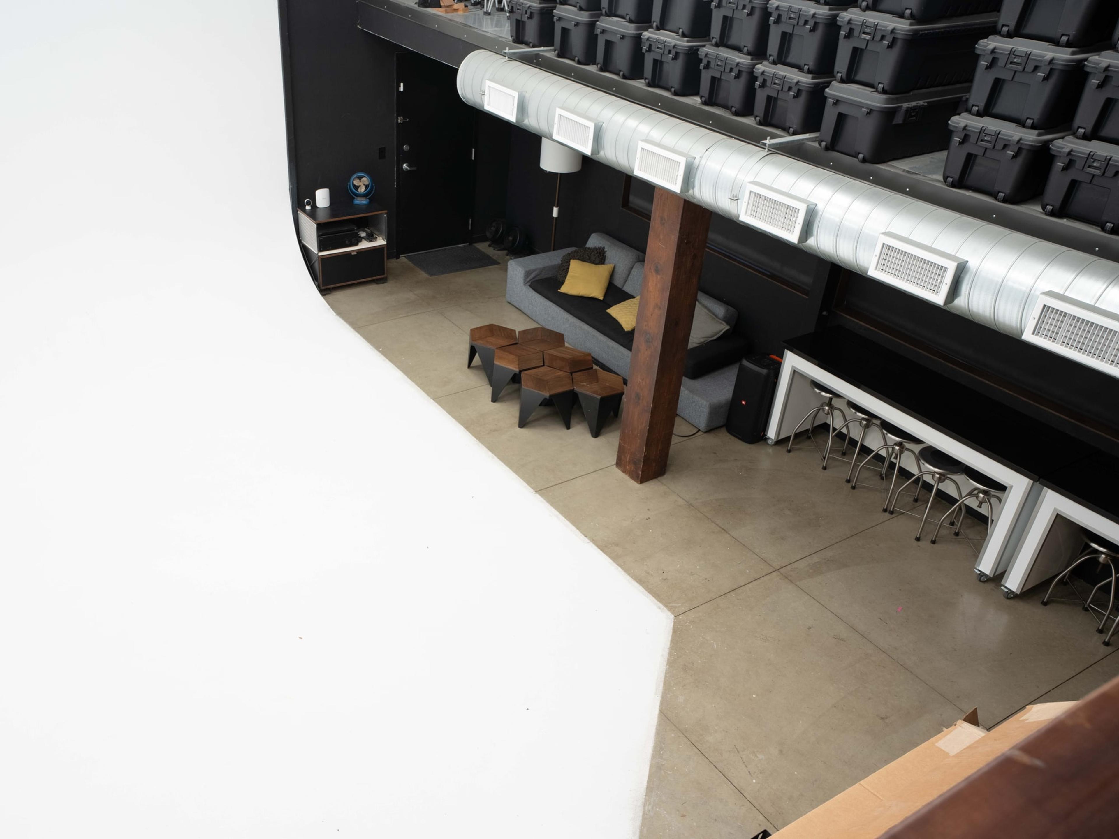 The cyclorama from above, road cases racked along the mezzanine beside it