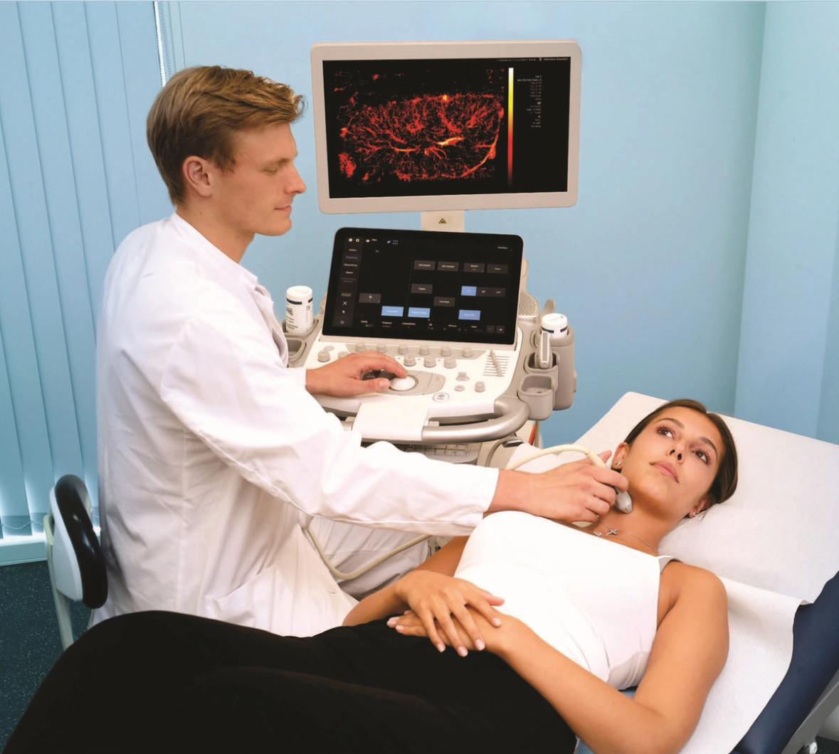 Doctor scanning a patient's throat with an US probe, with a screen showing the US image with visualisation graphics