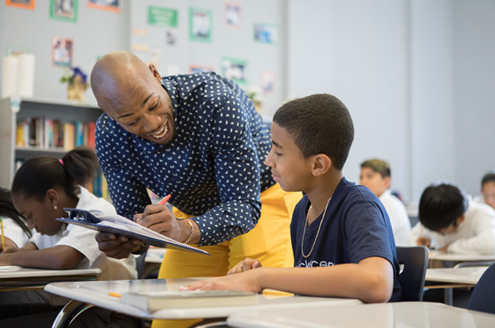 Ascend teacher connecting with student and smiling