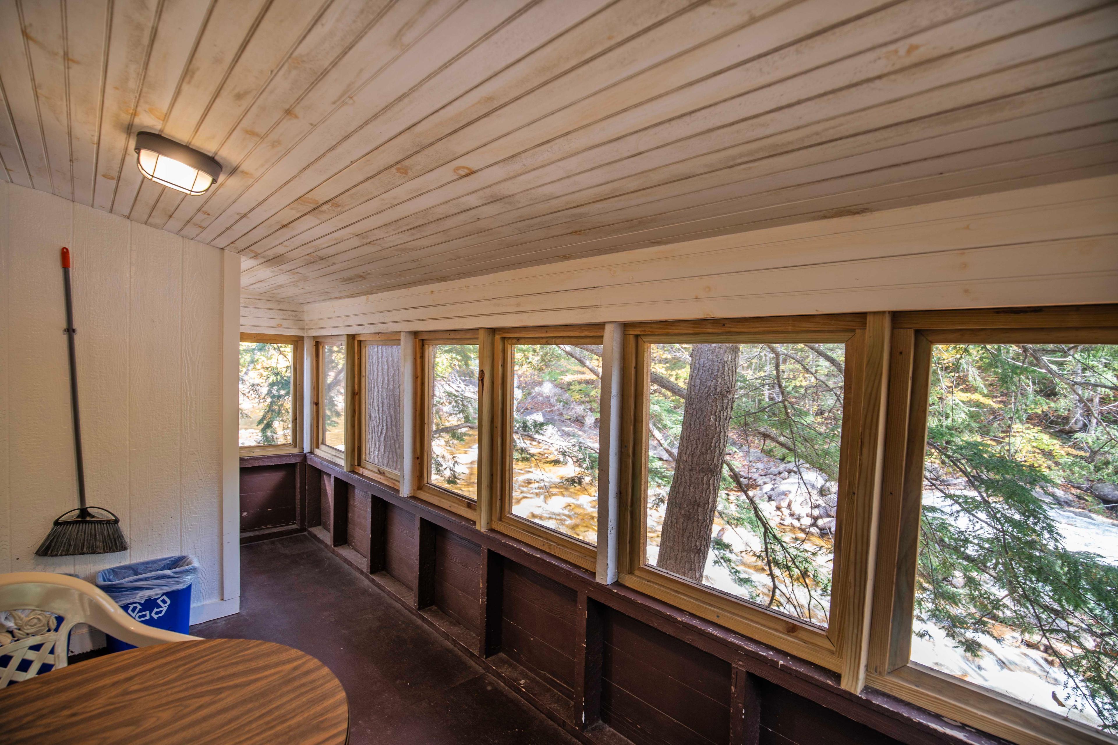 Enjoy morning coffee or a romantic dinner on Beaver Pond's screened-in porch. #PeacefulRetreat #FirewoodAvailable #RomanticCabin #ScenicPorch