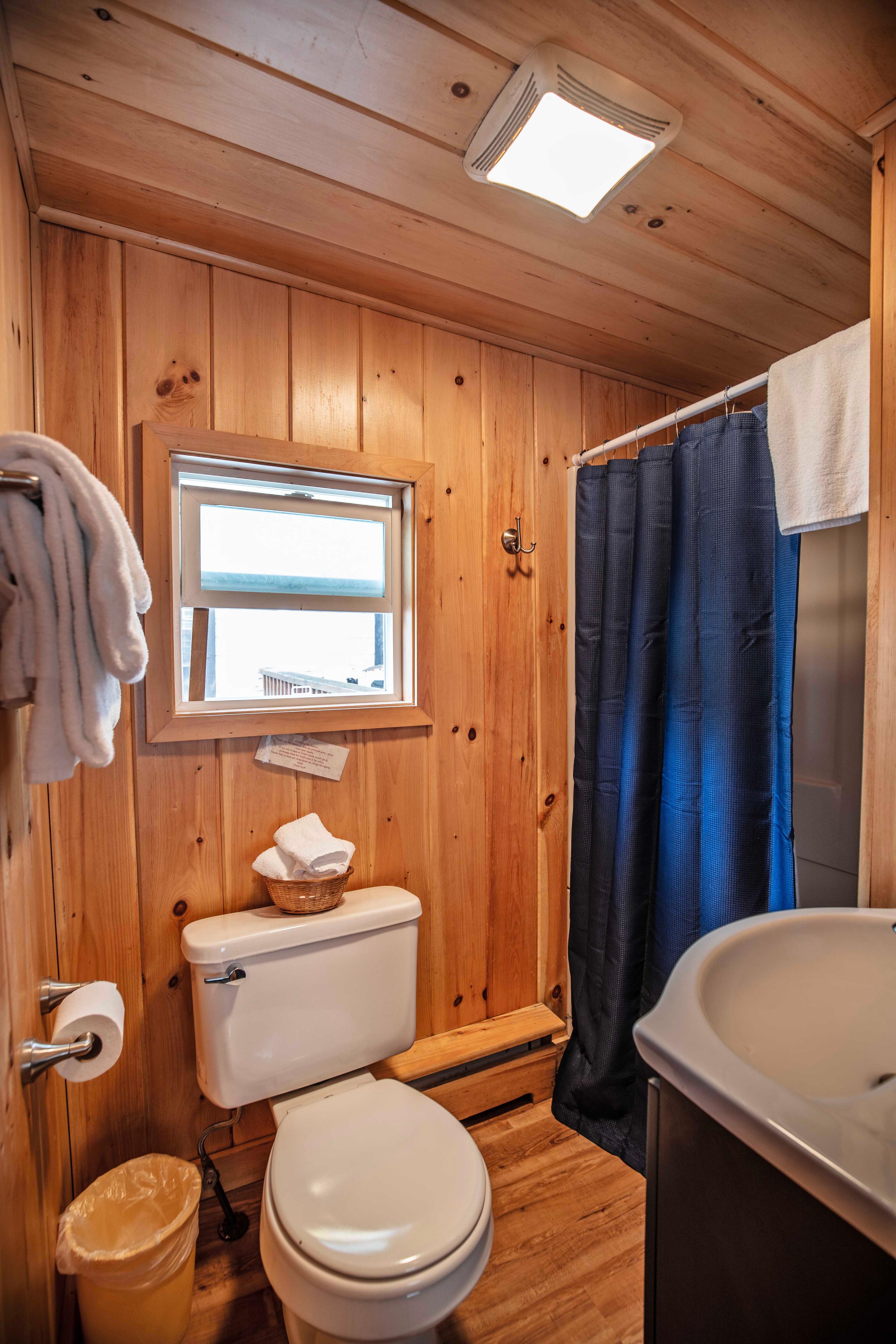 Full bathroom with stand-up shower adjacent to the bedroom in The Flume cabin.  #EveningRelaxation #ScreenedInPorch #CozyLivingRoom #FullBathroom