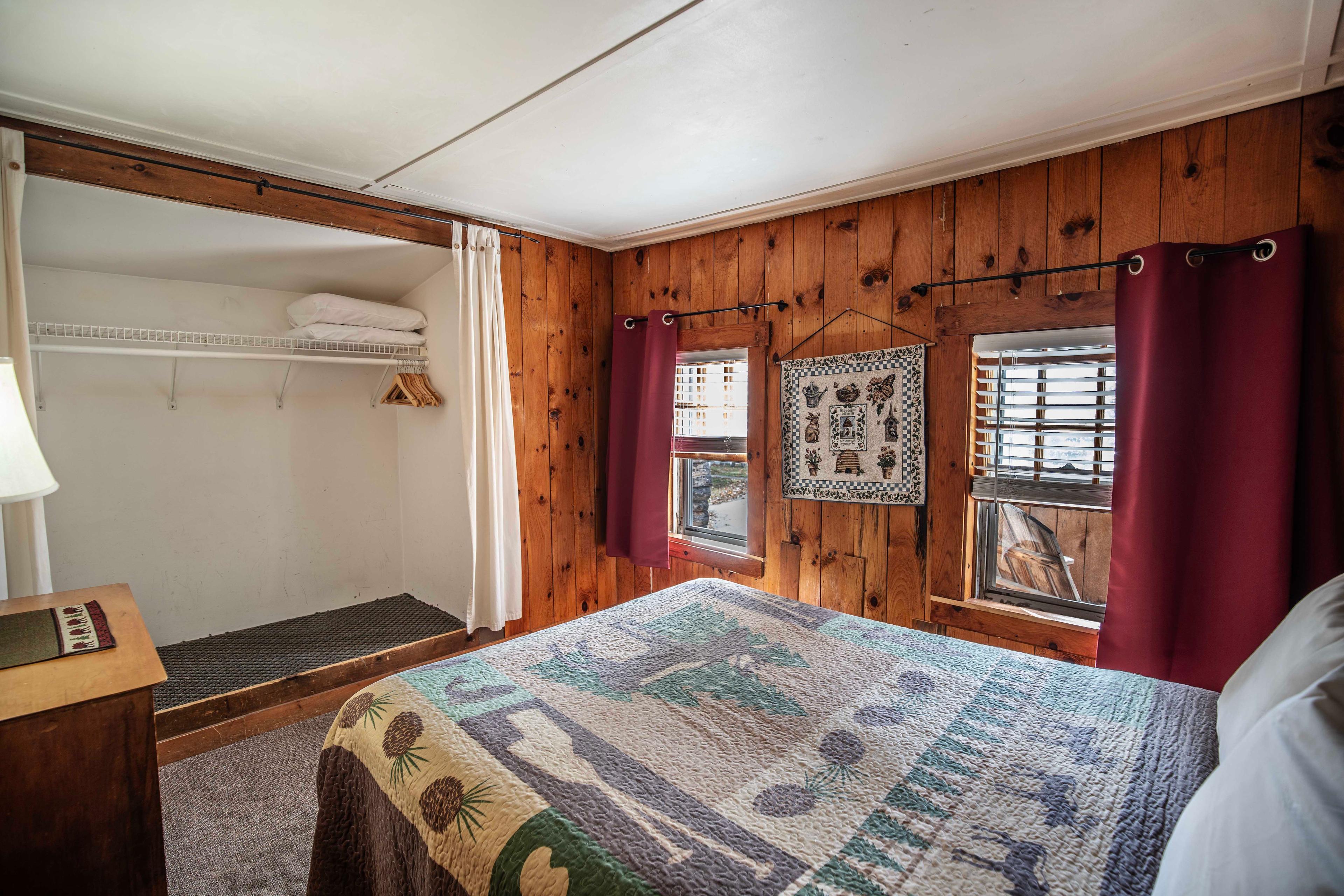 Cozy bedroom setup with plush queen-sized bed at The Pemi Trail. #Staycation #NatureLovers #HomeAwayFromHome #CabinLife