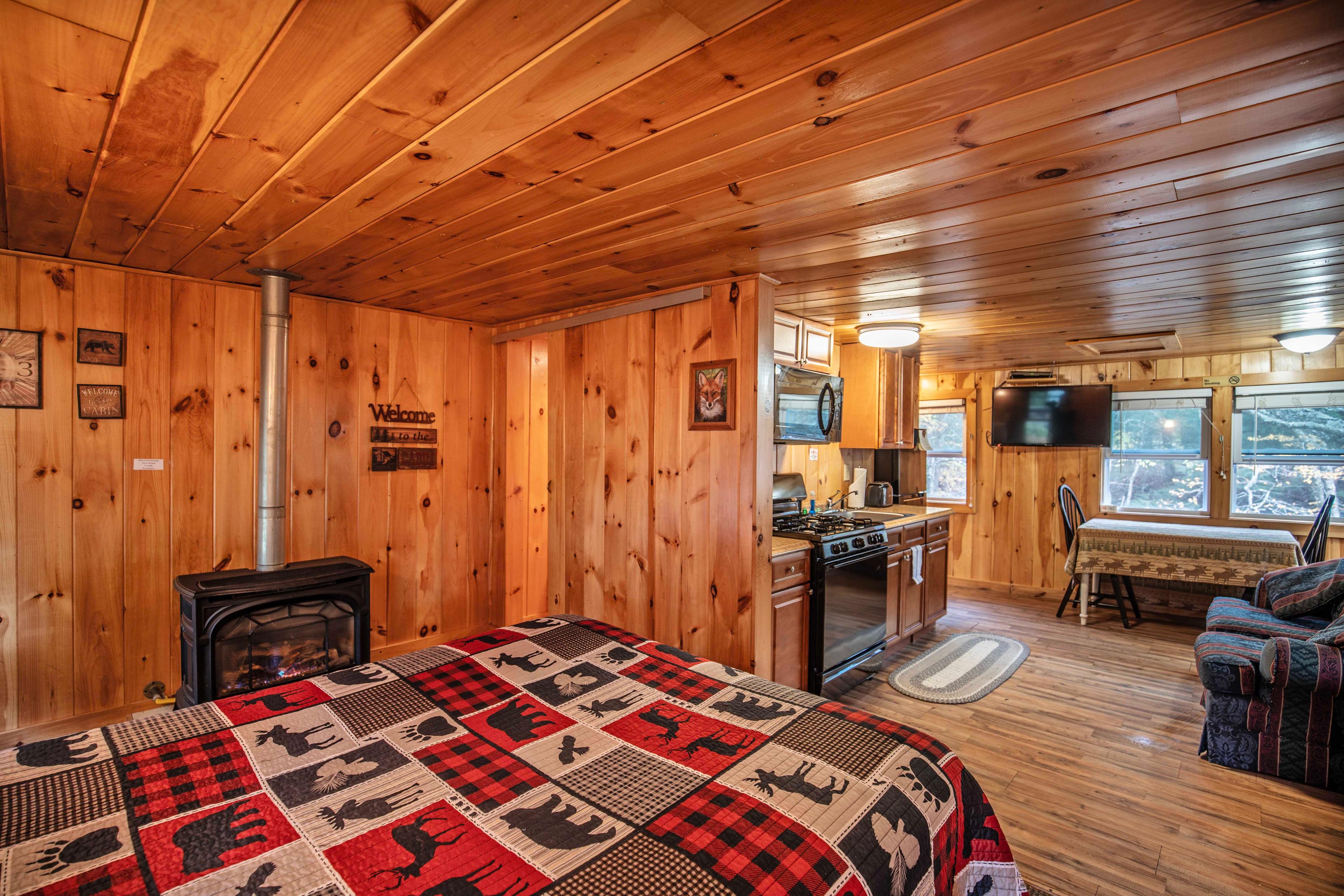 Open layout connecting bedroom and living area in Fox Hollow cabin. #OutdoorDining #CozyCabin #FirepitNights #RusticCharm