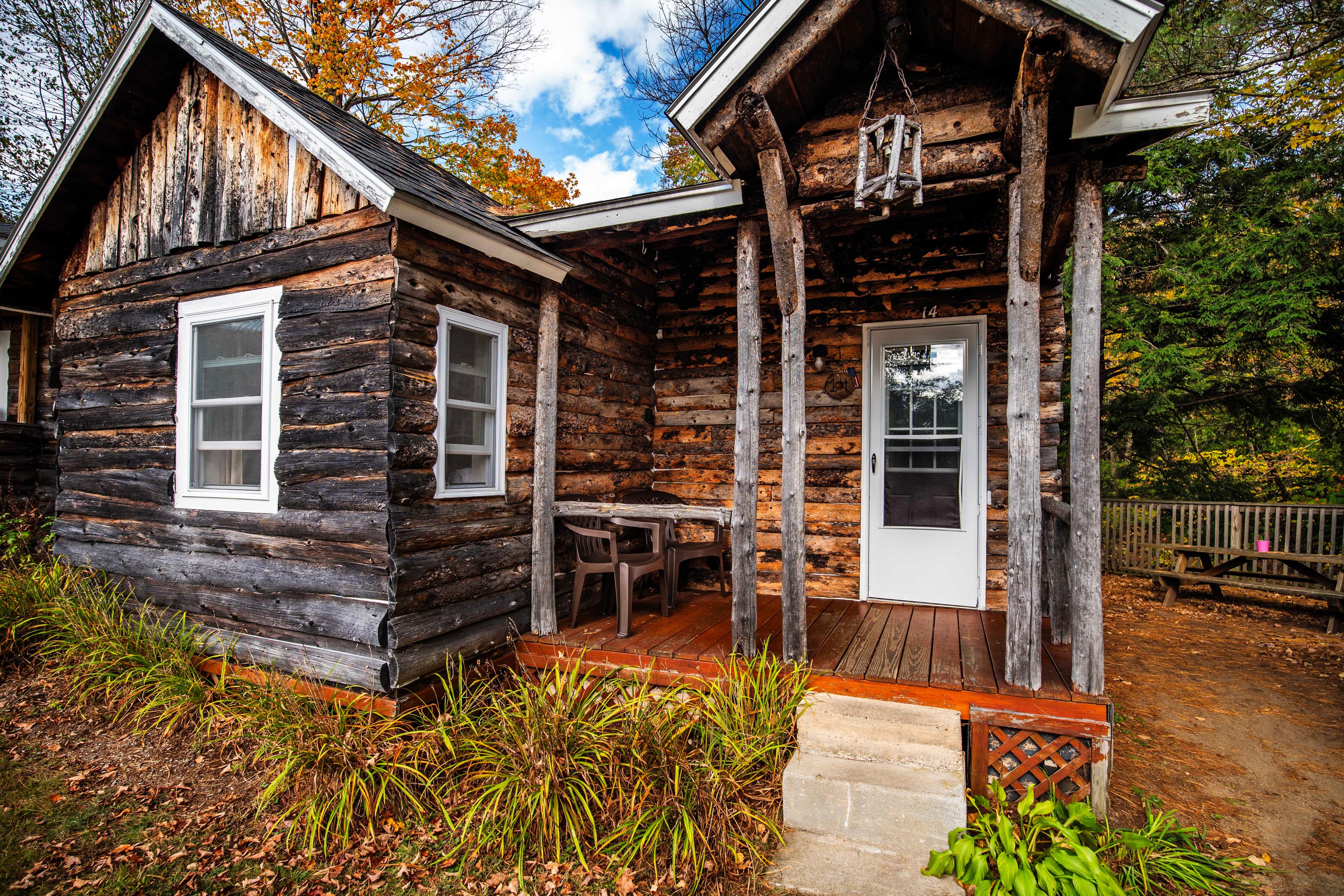 Front porch with seating to relax and enjoy the peaceful surroundings at Mount Lincoln. #CabinLife #NatureEscape #OutdoorAdventures #ExploreNH