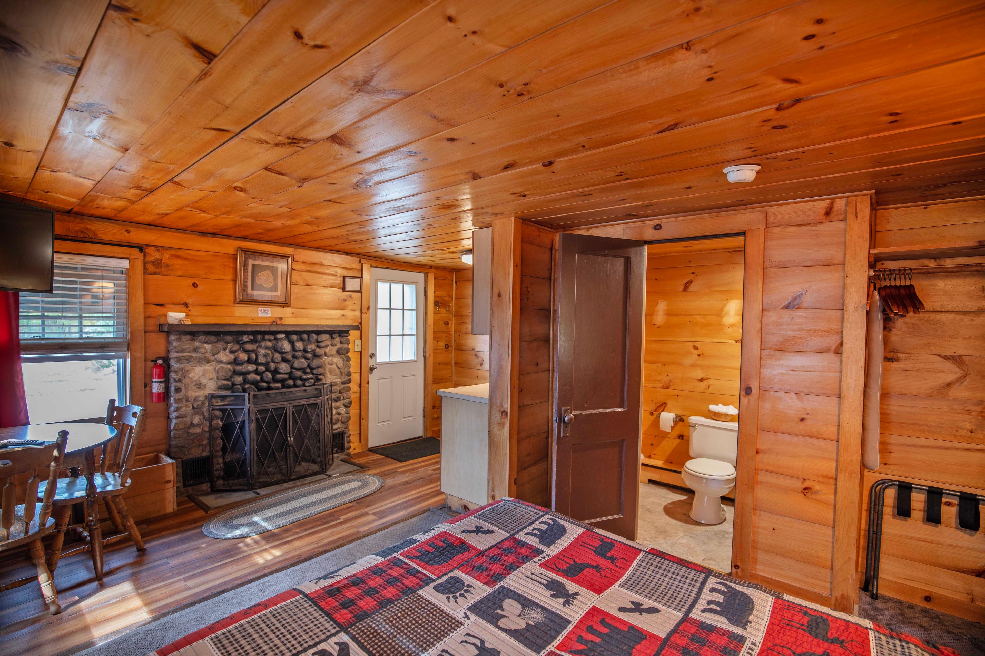 Warm ambiance provided by the wood-burning fireplace at Lost River. #RiverViews #PeacefulRetreat #FirewoodAvailable #RomanticCabin