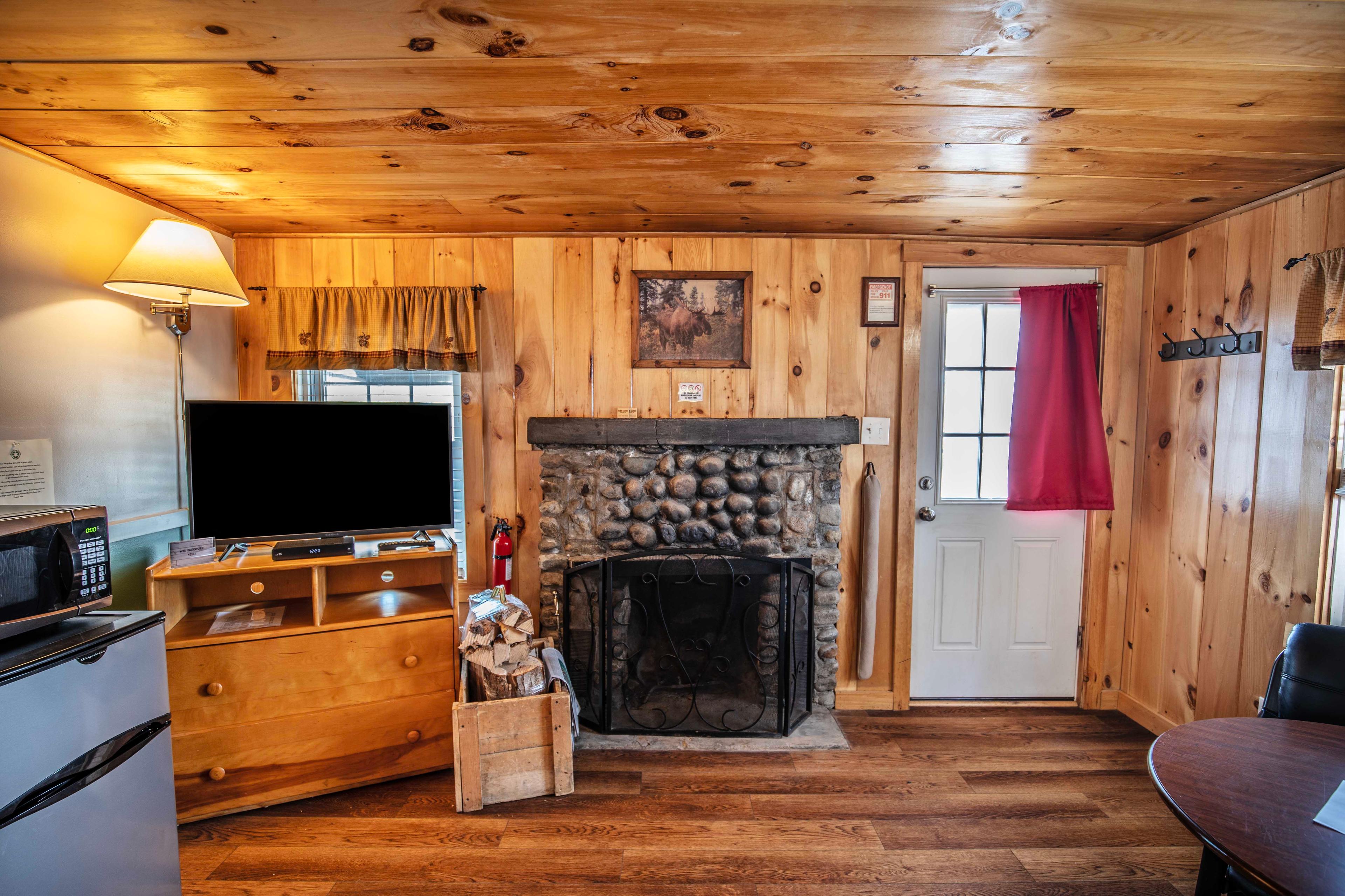 Cozy up by the wood-burning fireplace with mantle at The Basin cabin. #LincolnNH #WhiteMountains #CabinRetreat #NatureEscape