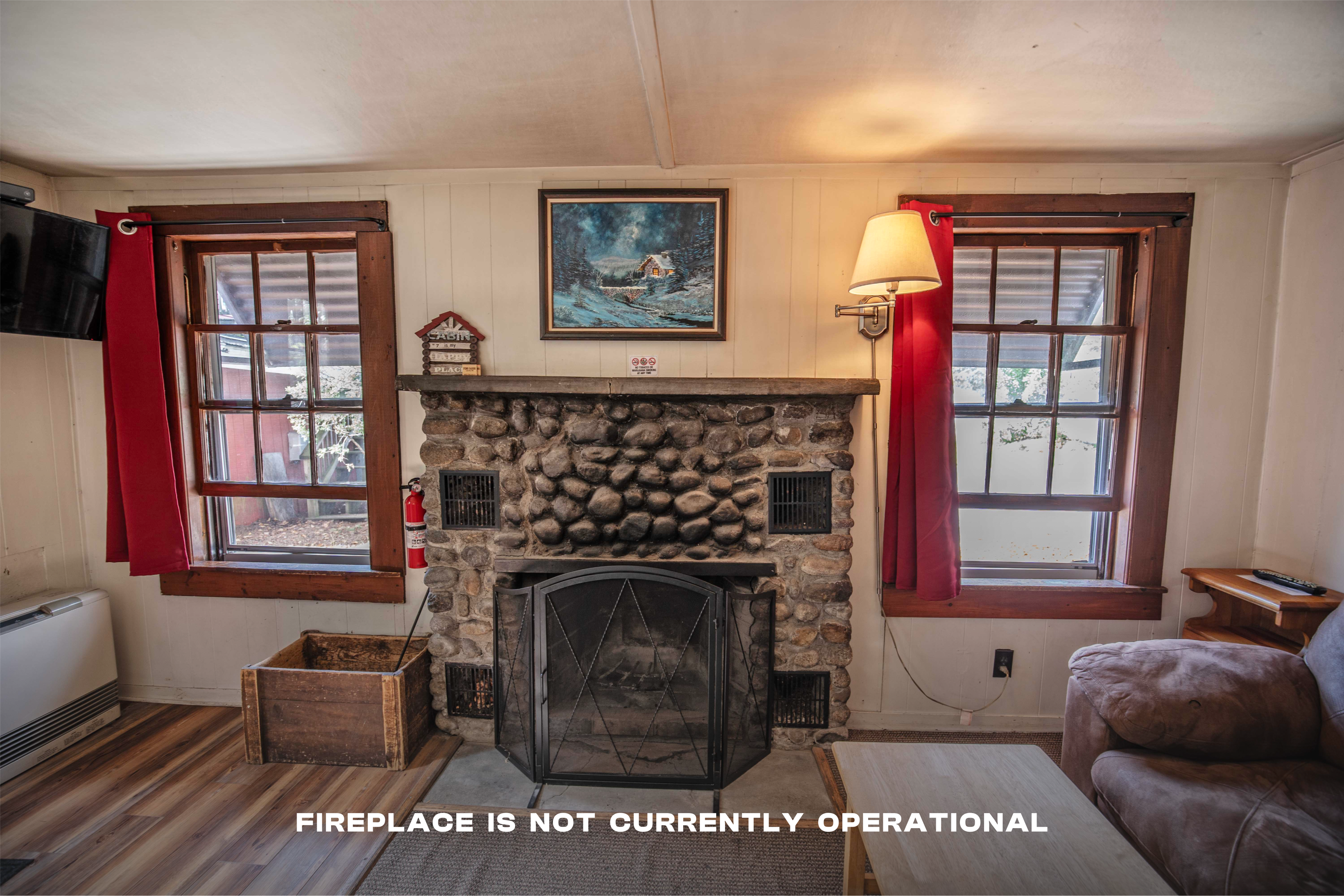 Stunning riverstone fireplace and mantle in Falling Waters cabin. #FireplaceNights #RusticCharm #NatureLovers #CabinGetaway