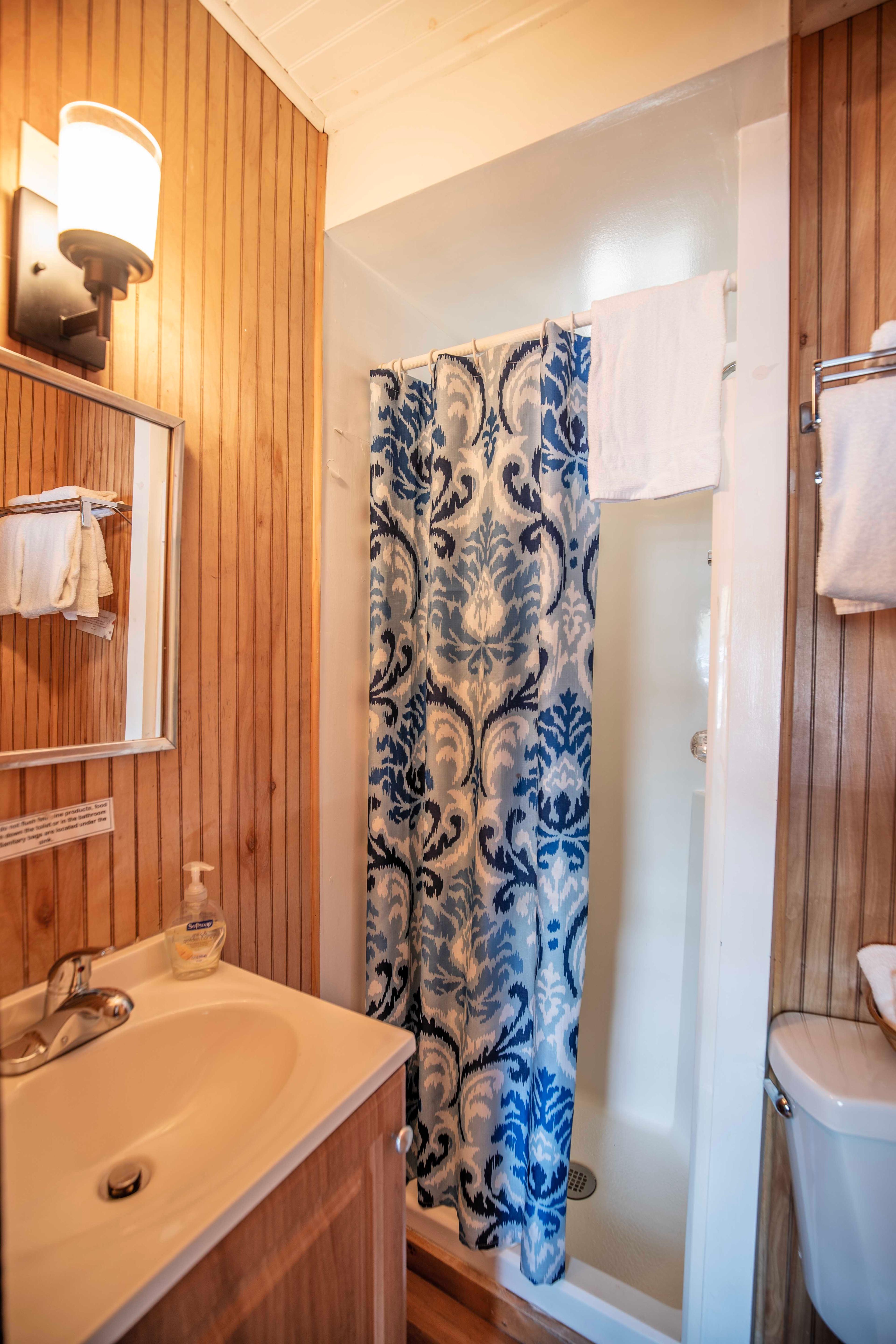 Full bathroom with stand-up shower conveniently located off the bedroom in Deer Haven. #CozyLivingRoom #FullBathroom #HiddenGem #NatureBeauty