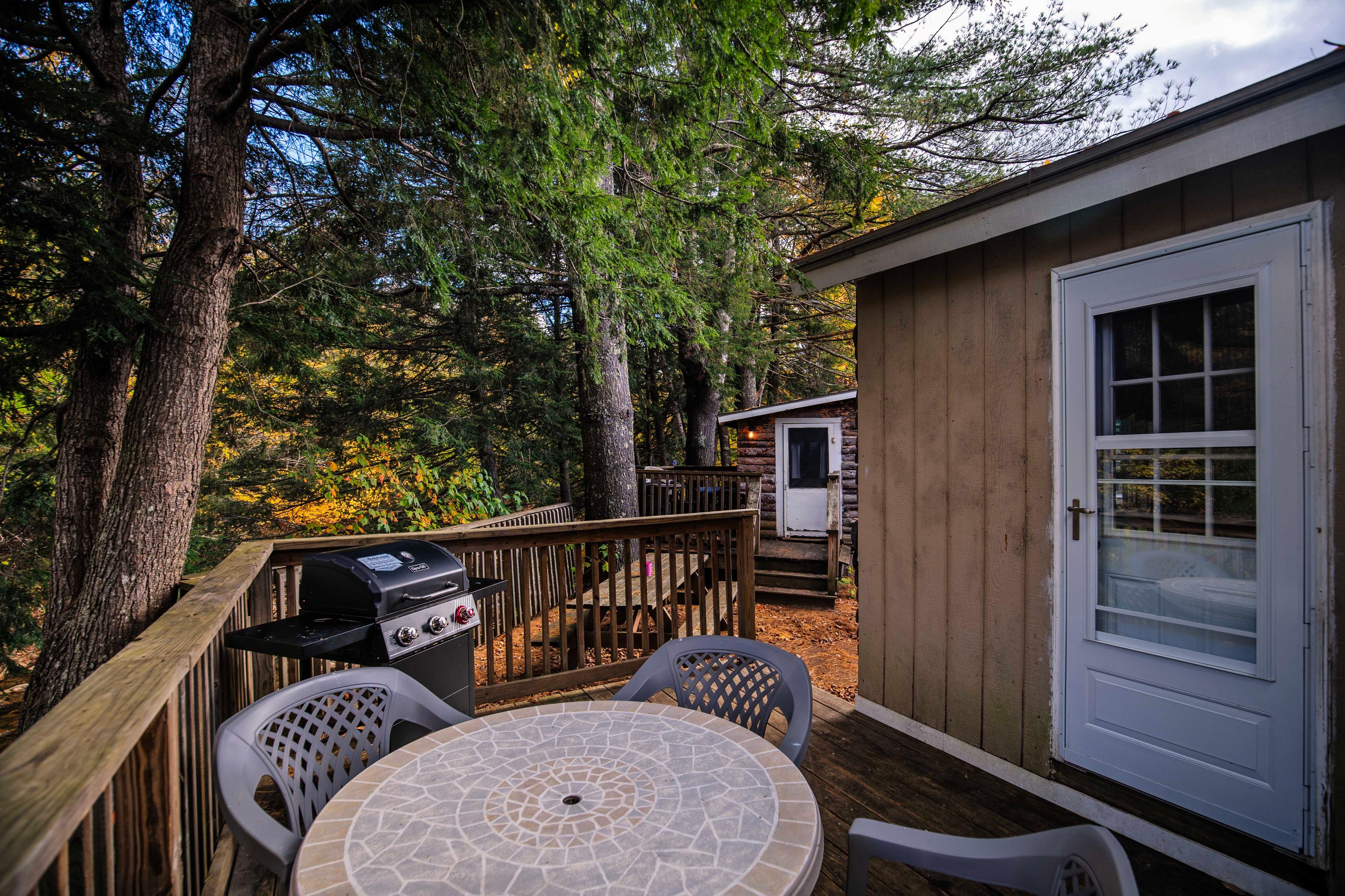 Picnic table for gatherings between cabins 12 and 14 at Pemi Cabins. #YearRoundComfort #PicnicArea #CabinLife #NatureEscape