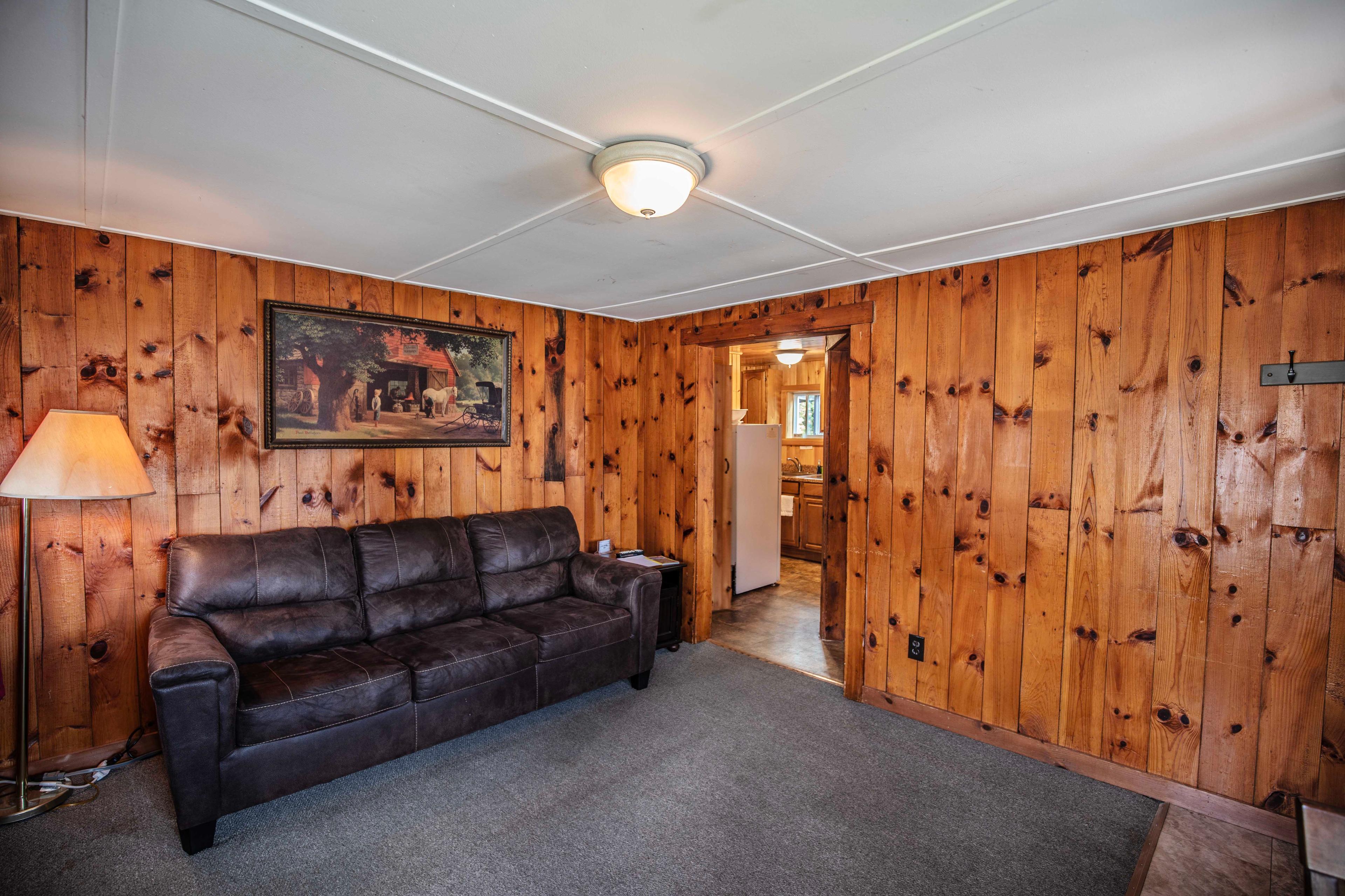 Cozy corner for relaxation in The Pemi Trail cabin. #RiverfrontEscape #OutdoorAdventures #RomanticGetaway #FamilyVacation