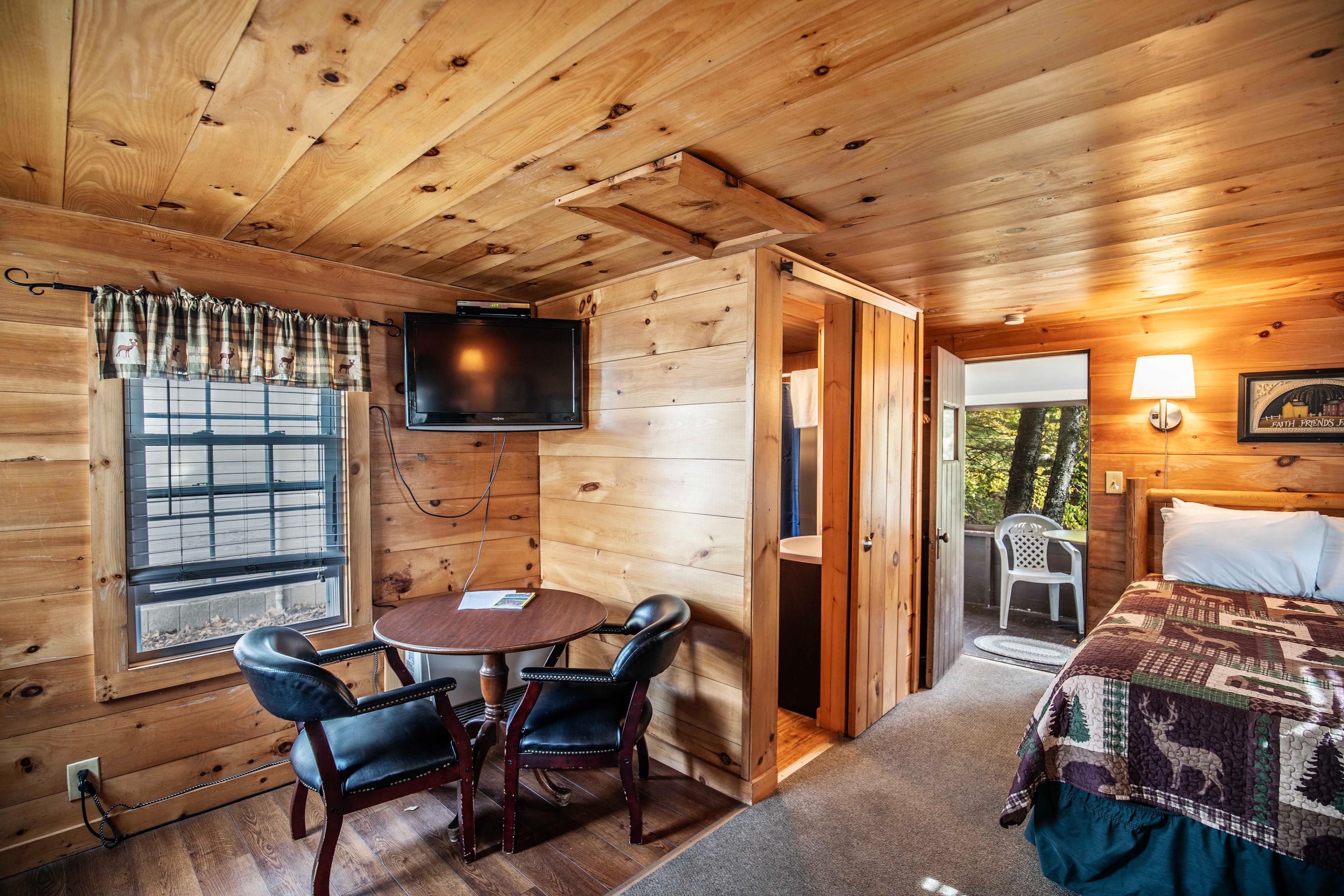 Small dining table with seating in The Flume cabin. #LincolnNH #WhiteMountains #CabinRetreat #NatureEscape