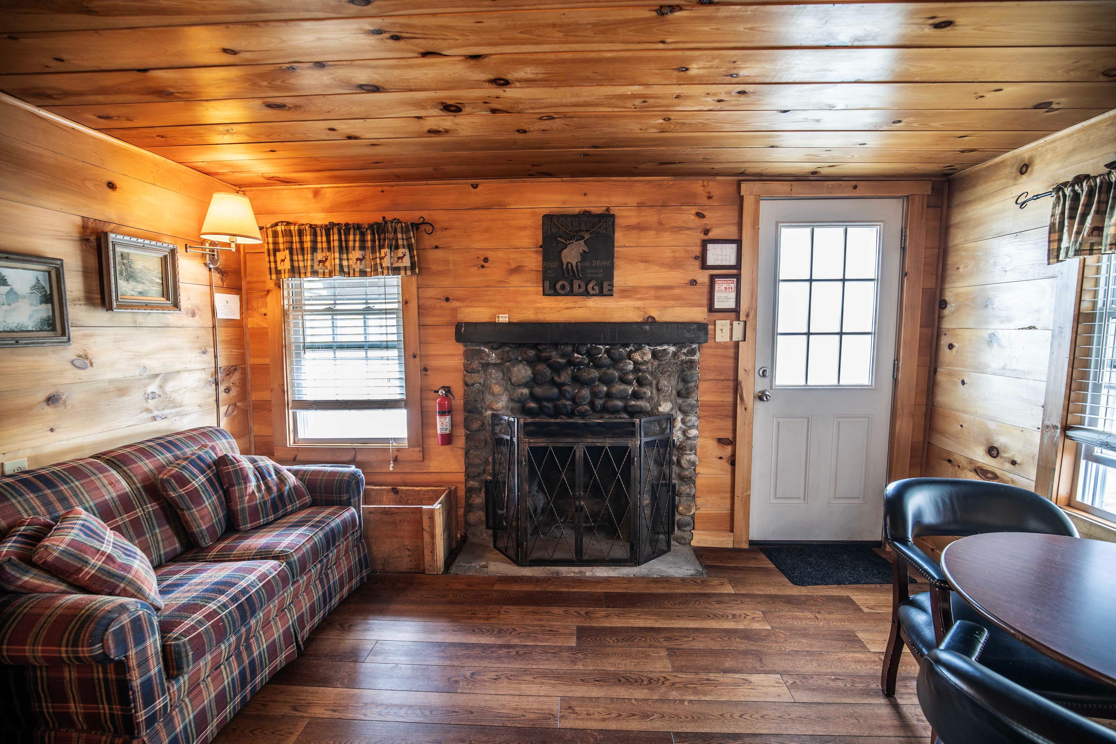 Warm ambiance provided by the fireplace at The Flume cabin. #RomanticGetaway #UnforgettableGetaway #CabinInTheWoods #RelaxationSpot