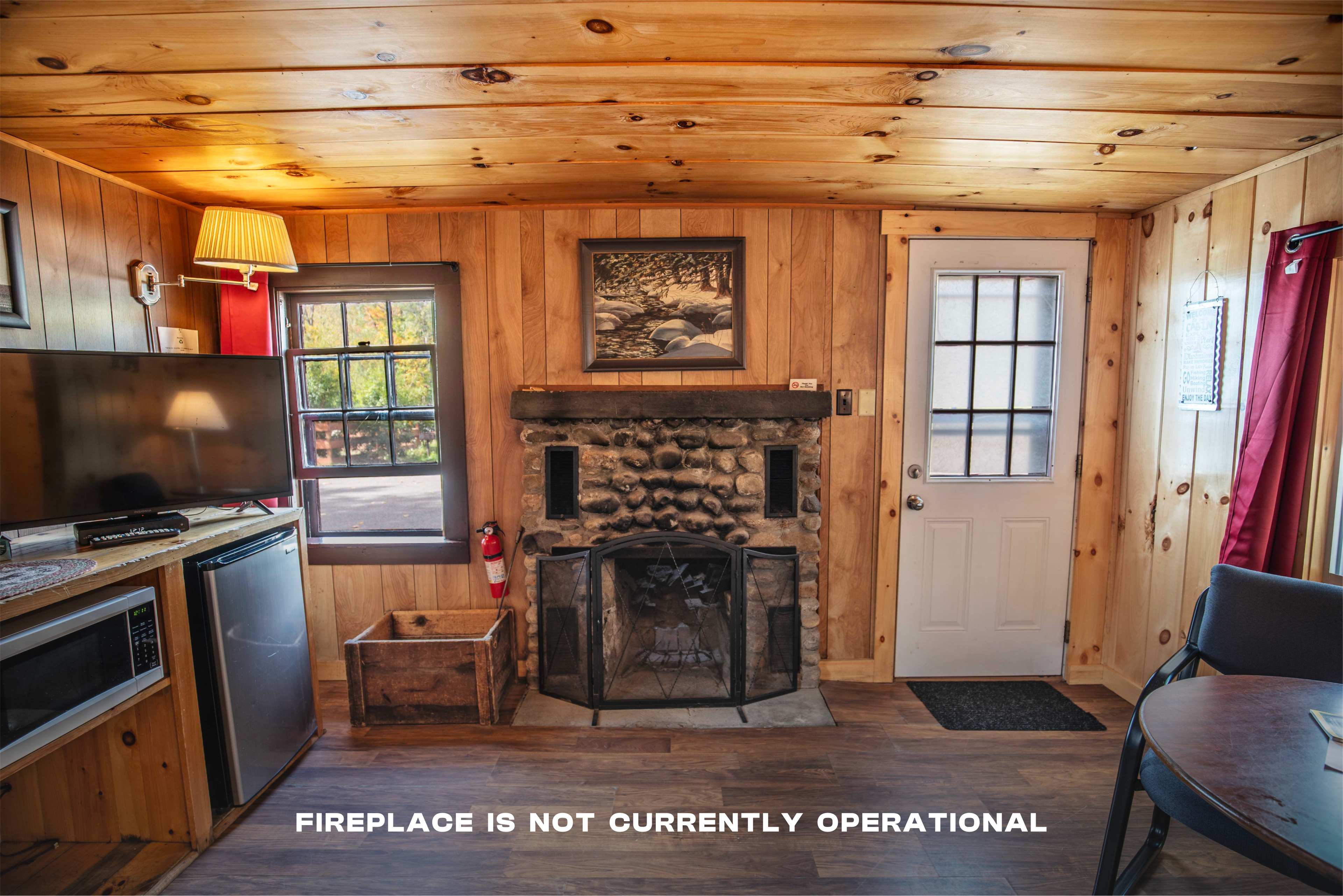 Riverstone fireplace adds to the cozy ambiance of Cathedral Ledge cabin. #HiddenGem #EscapeTheCity #PeacefulRetreat #CozyAtmosphere