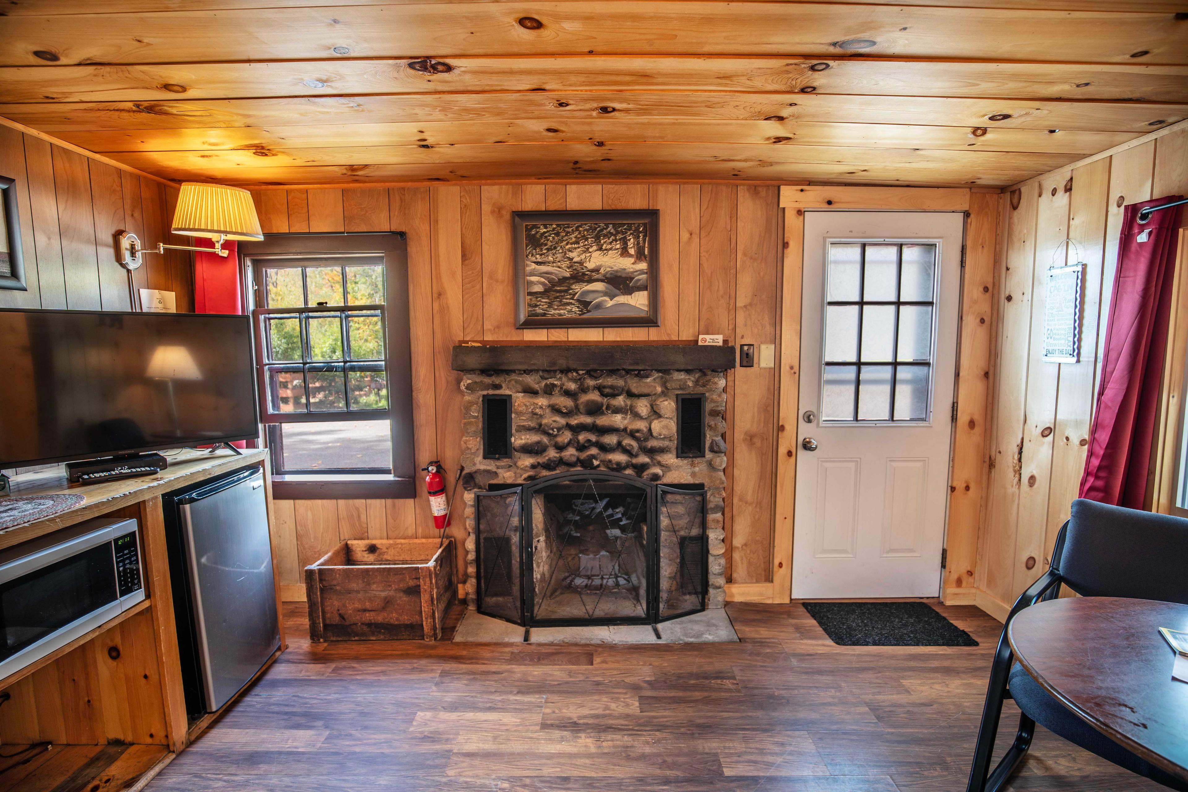 Riverstone fireplace adds to the cozy ambiance of Cathedral Ledge cabin. #HiddenGem #EscapeTheCity #PeacefulRetreat #CozyAtmosphere