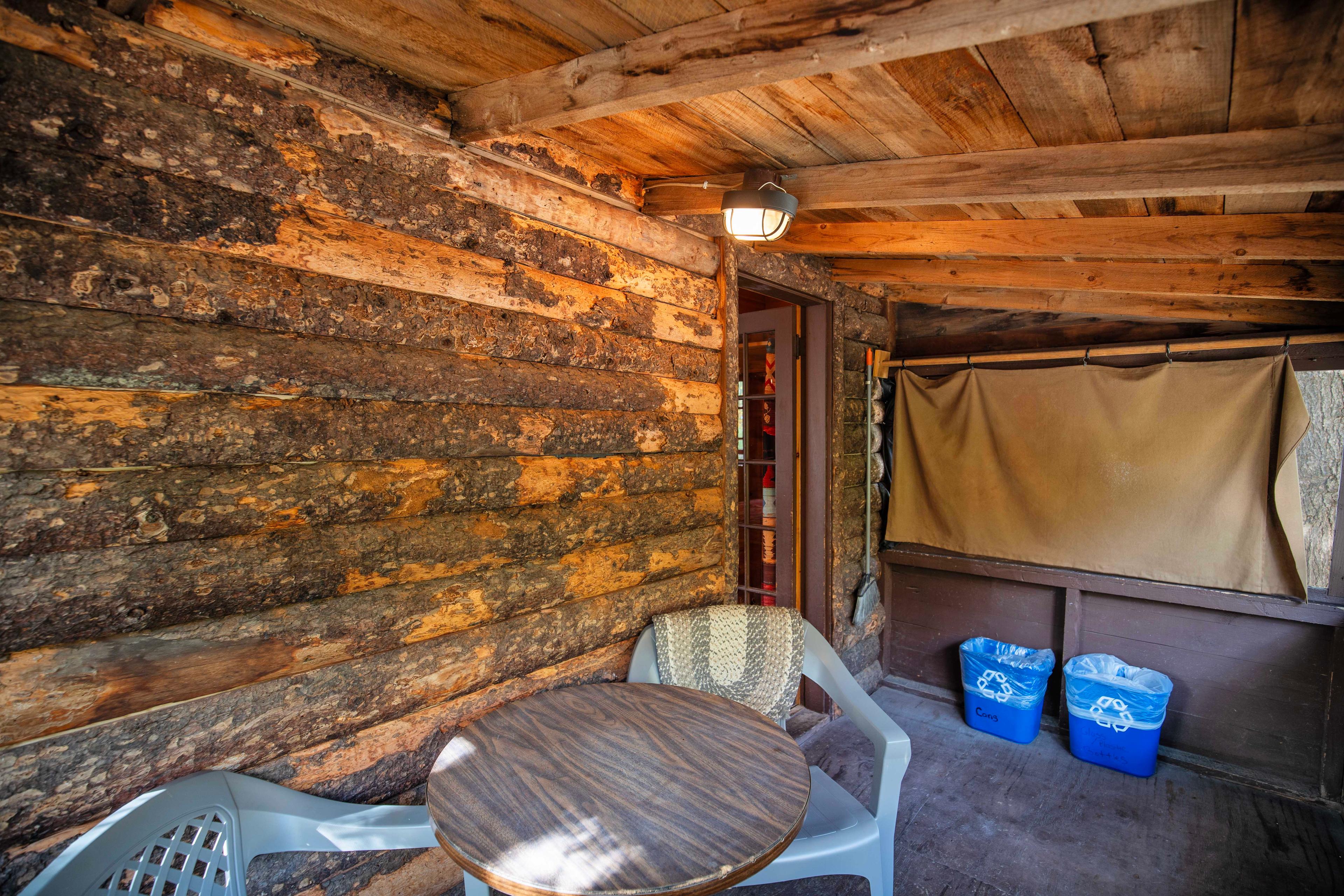 Outdoor relaxation on the porch of The River Otter cabin. #WhiteMountains #CabinRetreat #NatureEscape #CozyCabin