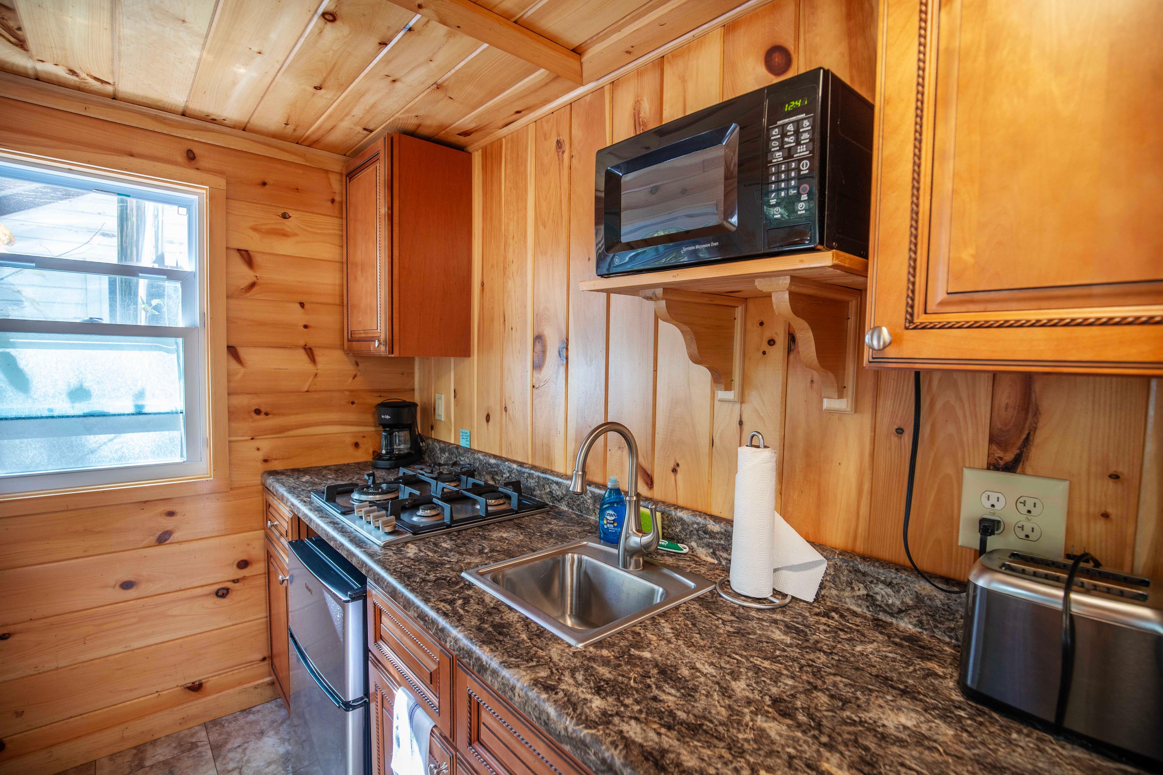 Kitchen gadgets and utensils provided for meal preparation in Falling Waters cabin. #CozyLivingRoom #FullBathroom #HiddenGem #NatureBeauty