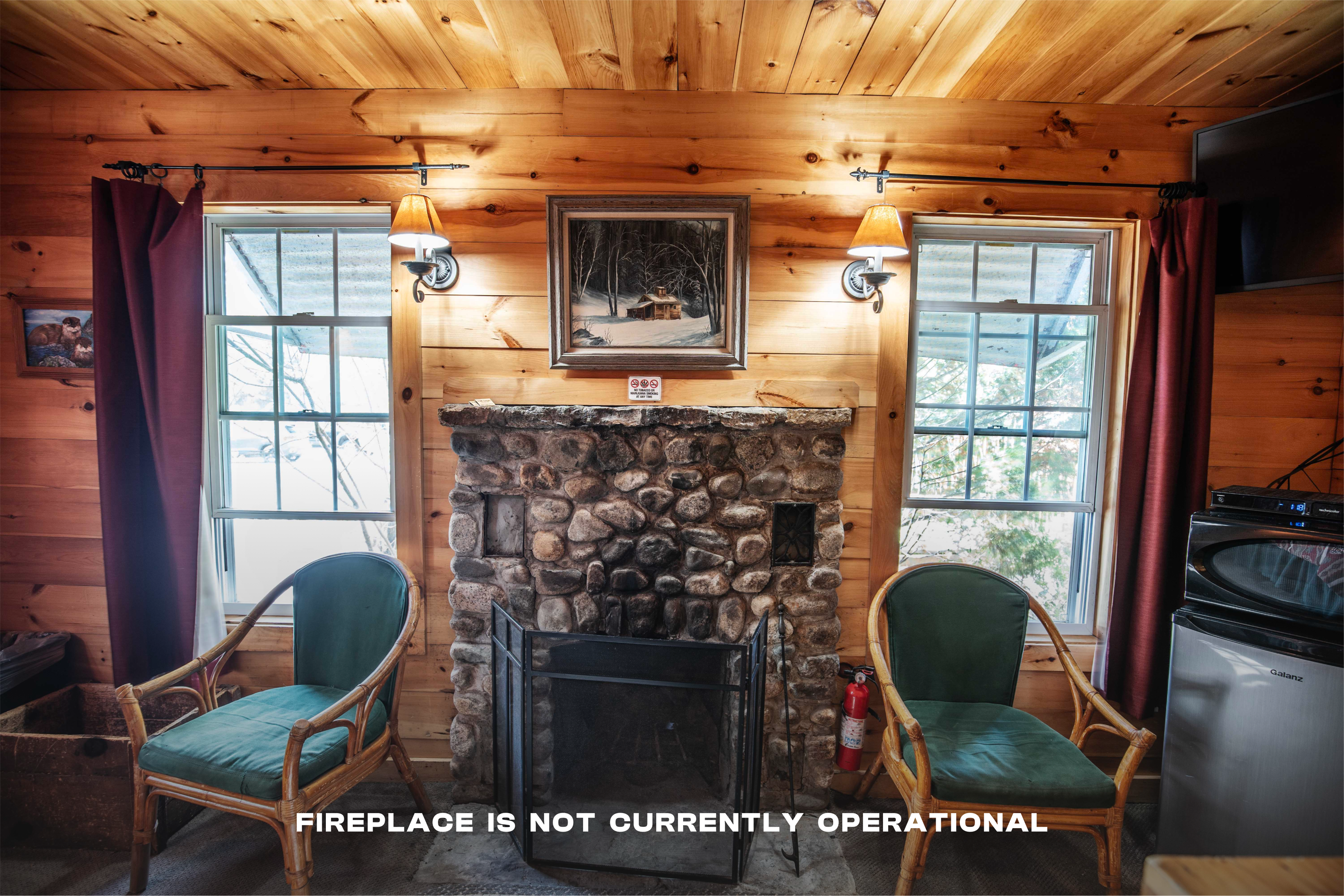 Cozy ambiance created by the wood-burning fireplace in The River Otter. #WoodBurningFireplace #RusticMeetsModern #RiverViews #PeacefulRetreat