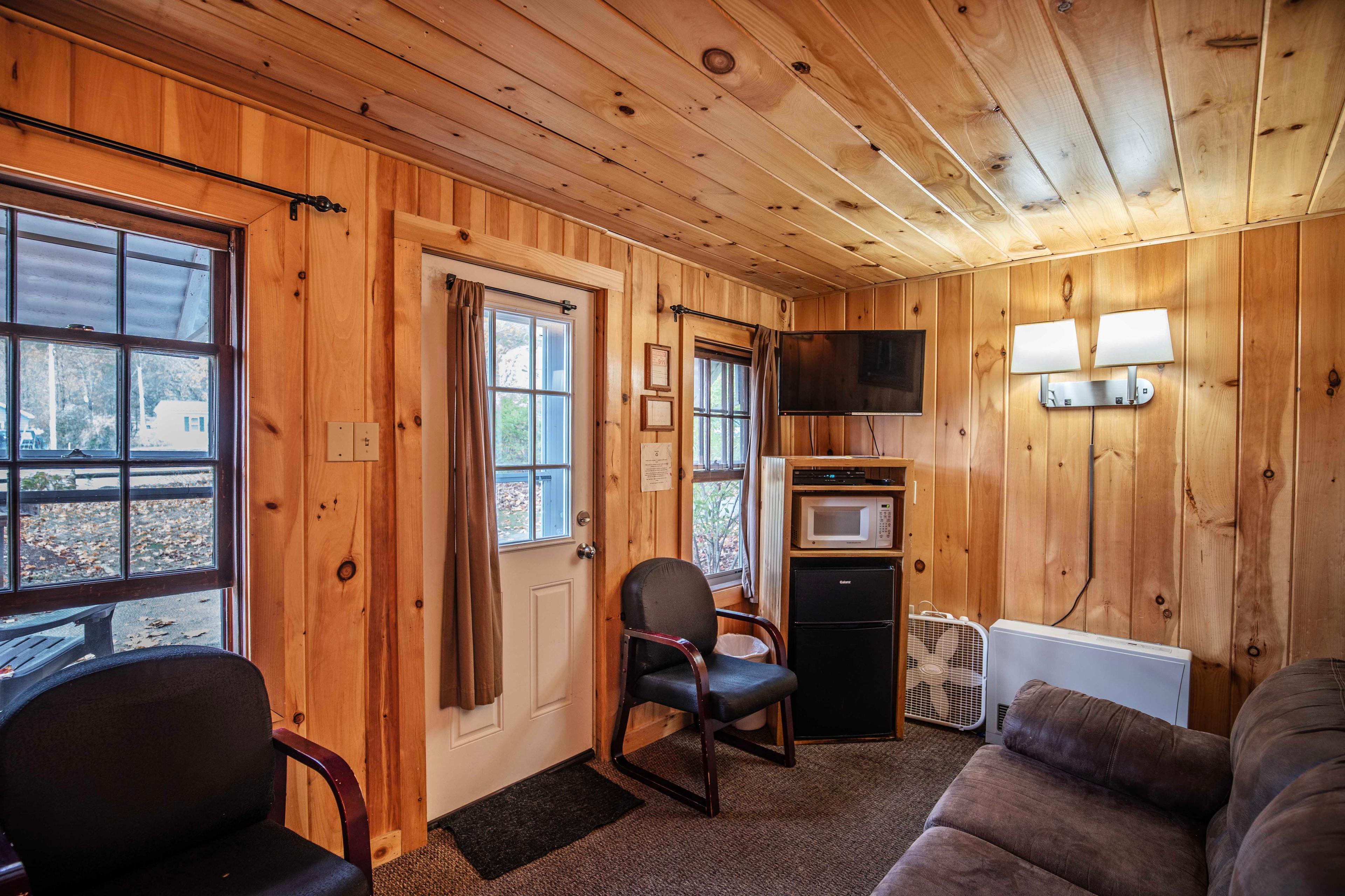 Relax on the screened-in porch of The Moose's Antler with river views. #FamilyVacation #ScenicPorch #MorningCoffee #EveningRelaxation