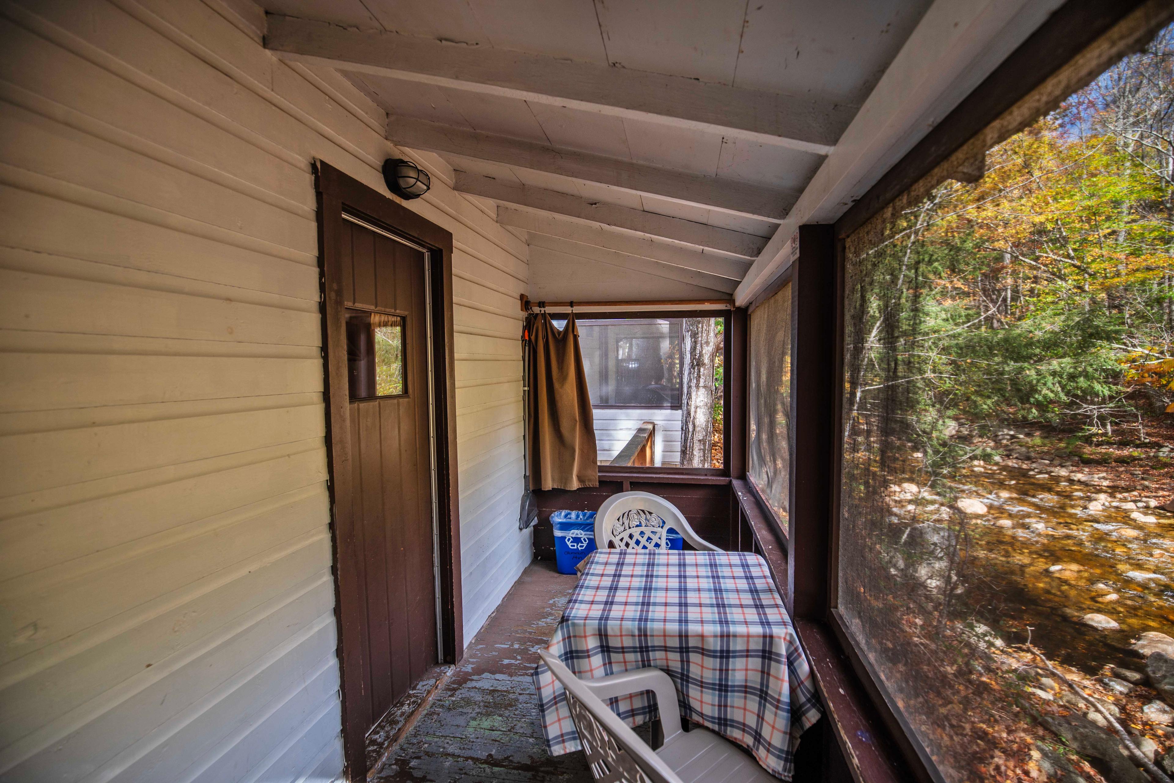 Tranquil retreat with stunning riverfront views at The Basin cabin. #CabinInTheWoods #RelaxationSpot #OutdoorDining #MorningCoffee