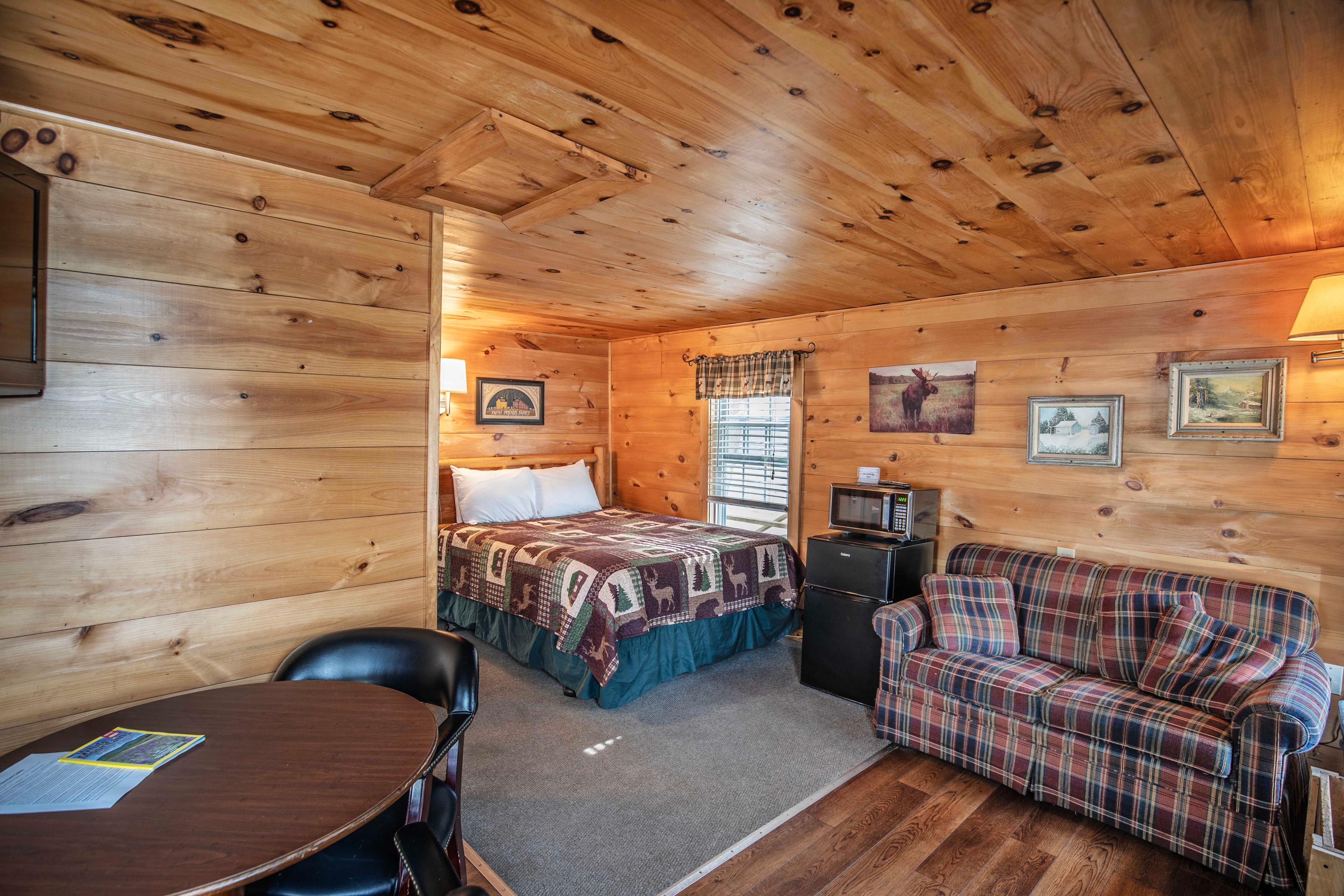 Cozy and inviting atmosphere with riverstone fireplace at The Flume cabin. #CozyCabin #FireplaceNights #RusticCharm #NatureLovers