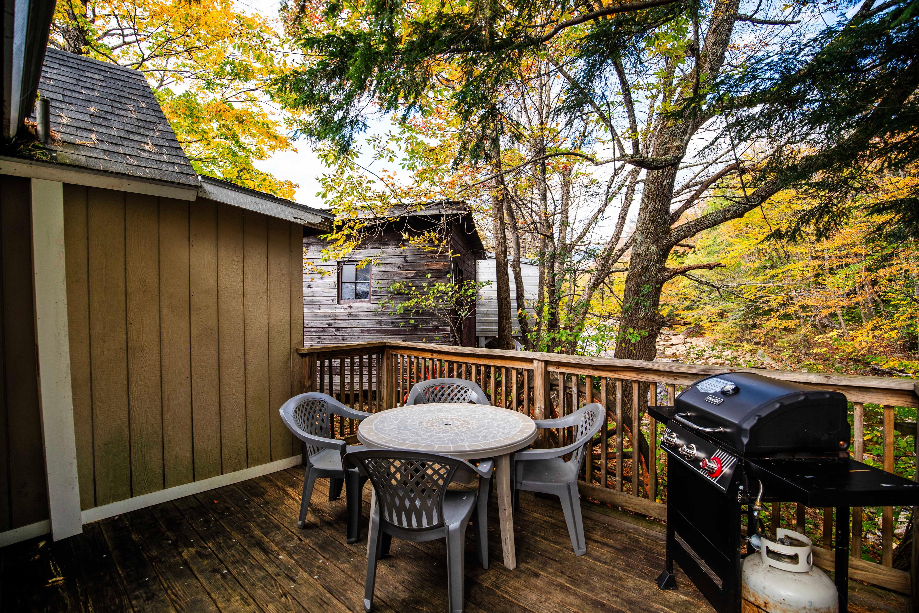 Private outdoor deck with propane grill and river views at Mount Lincoln cabin. #PicnicArea  #OutdoorDeck #PropaneGrill #KitchenAmenities