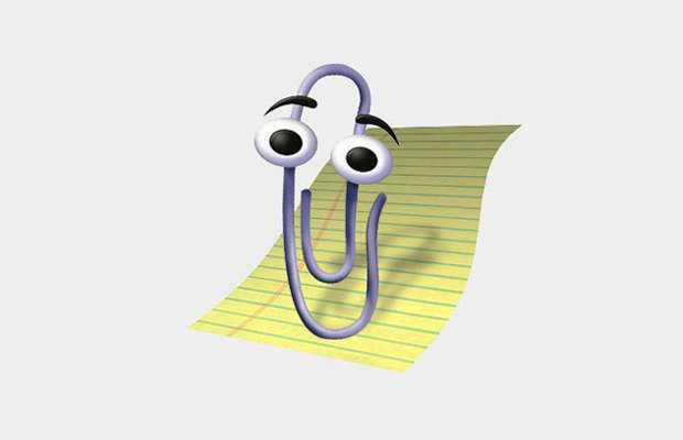Clippy, the Microsoft Office paperclip assistant, in front of a sheet of yellow lined paper