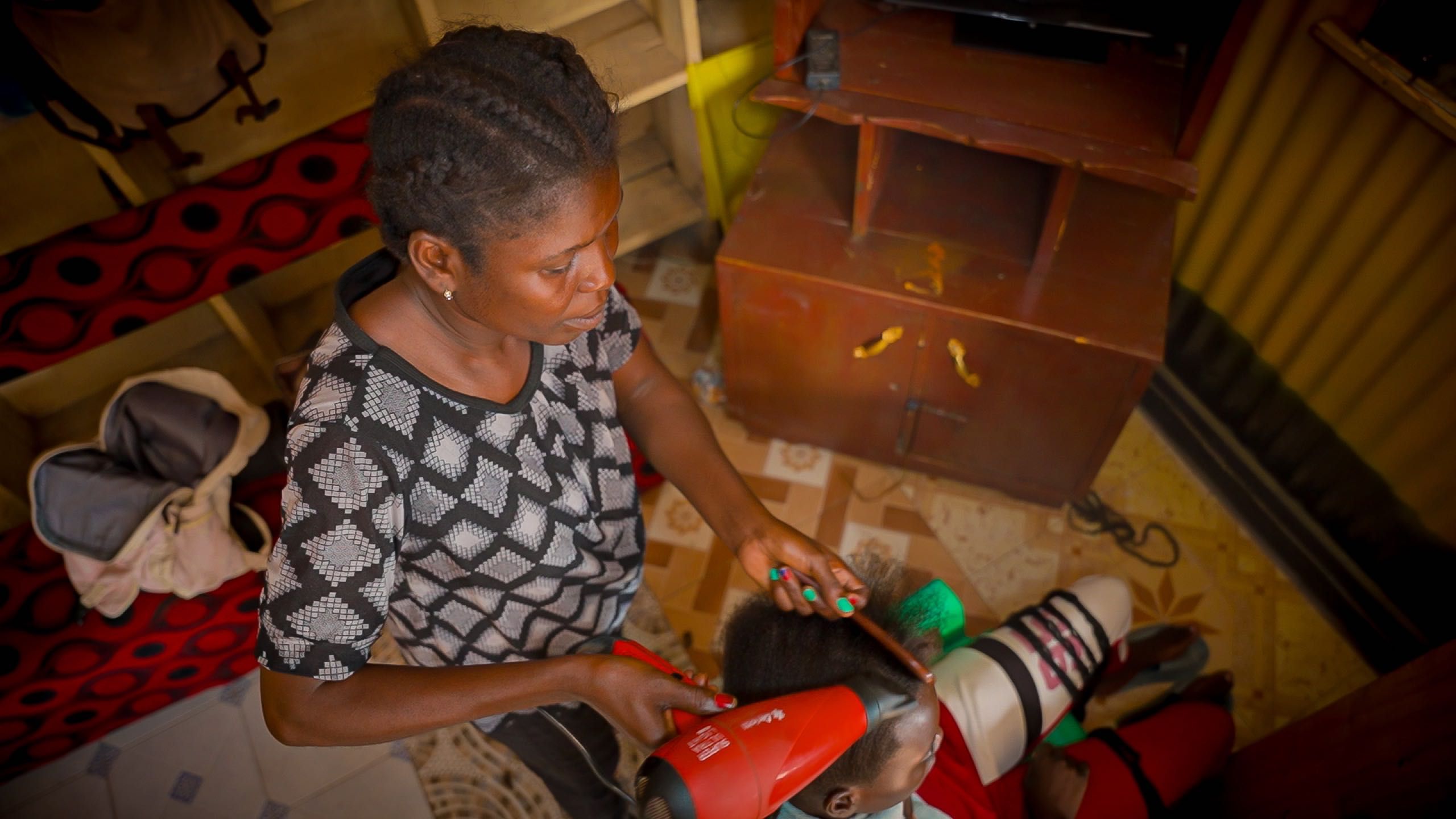 A woman braids a child's hair with a red hairdryer and a comb.​​​​‌﻿‍﻿​‍​‍‌‍﻿﻿‌﻿​‍‌‍‍‌‌‍‌﻿‌‍‍‌‌‍﻿‍​‍​‍​﻿‍‍​‍​‍‌﻿​﻿‌‍​‌‌‍﻿‍‌‍‍‌‌﻿‌​‌﻿‍‌​‍﻿‍‌‍‍‌‌‍﻿﻿​‍​‍​‍﻿​​‍​‍‌‍‍​‌﻿​‍‌‍‌‌‌‍‌‍​‍​‍​﻿‍‍​‍​‍‌‍‍​‌﻿‌​‌﻿‌​‌﻿​​​﻿‍‍​‍﻿﻿​‍﻿﻿‌‍﻿​‌‍﻿﻿‌‍​﻿‌‍​‌‌‍﻿​‌‍‍​‌‍﻿﻿‌﻿​﻿‌﻿‌​​﻿‍‍​﻿​﻿​﻿​﻿​﻿​﻿​﻿​﻿​‍﻿﻿‌‍‍‌‌‍﻿‍‌﻿‌​‌‍‌‌‌‍﻿‍‌﻿‌​​‍﻿﻿‌‍‌‌‌‍‌​‌‍‍‌‌﻿‌​​‍﻿﻿‌‍﻿‌‌‍﻿﻿‌‍‌​‌‍‌‌​﻿﻿‌‌﻿​​‌﻿​‍‌‍‌‌‌﻿​﻿‌‍‌‌‌‍﻿‍‌﻿‌​‌‍​‌‌﻿‌​‌‍‍‌‌‍﻿﻿‌‍﻿‍​﻿‍﻿‌‍‍‌‌‍‌​​﻿﻿‌​﻿​​​﻿‍​‌‍‌​​﻿​‍​﻿​‍​﻿​​​﻿​‍​﻿‌‌​‍﻿‌‌‍‌‍​﻿​﻿‌‍‌‌​﻿​​​‍﻿‌​﻿‌​​﻿​﻿​﻿‌​‌‍​‍​‍﻿‌​﻿‍​‌‍‌‍​﻿​﻿‌‍​﻿​‍﻿‌​﻿​‌‌‍​‍​﻿‌​‌‍‌‍‌‍​‌​﻿‌‌​﻿​​​﻿​﻿​﻿‍‌​﻿‌‍​﻿‍​​﻿‌‍​﻿‍﻿‌﻿‌​‌﻿‍‌‌﻿​​‌‍‌‌​﻿﻿‌‌‍​﻿‌‍​‌‌﻿​﻿‌‍‌‌‌‌​﻿‌﻿‌​‌﻿‌‌‌‍‌​‌﻿‍‌​﻿‍﻿‌﻿​​‌‍​‌‌﻿‌​‌‍‍​​﻿﻿‌‌‍​‍‌‍﻿﻿‌‍‌​‌﻿‍‌​‍‌‌​﻿‌‌‌​​‍‌‌﻿﻿‌‍‍﻿‌‍‌‌‌﻿‍‌​‍‌‌​﻿​﻿‌​‌​​‍‌‌​﻿​﻿‌​‌​​‍‌‌​﻿​‍​﻿​‍​﻿‍​​﻿​‌​﻿​‌​﻿​‍​﻿​​​﻿‍​‌‍​‍​﻿​​​﻿​‍​﻿‍​‌‍‌‌​﻿​﻿​‍‌‌​﻿​‍​﻿​‍​‍‌‌​﻿‌‌‌​‌​​‍﻿‍‌‍‍‌‌‍﻿‌‌‍​‌‌‍‌﻿‌‍‌‌​‍﻿‍‌‍​‌‌‍﻿​‌﻿‌​​﻿﻿﻿‌‍​‍‌‍​‌‌﻿​﻿‌‍‌‌‌‌‌‌‌﻿​‍‌‍﻿​​﻿﻿‌‌‍‍​‌﻿‌​‌﻿‌​‌﻿​​​‍‌‌​﻿​﻿‌​​‌​‍‌‌​﻿​‍‌​‌‍​‍‌‌​﻿​‍‌​‌‍‌‍﻿​‌‍﻿﻿‌‍​﻿‌‍​‌‌‍﻿​‌‍‍​‌‍﻿﻿‌﻿​﻿‌﻿‌​​‍‌‌​﻿​﻿‌​​‌​﻿​﻿​﻿​﻿​﻿​﻿​﻿​﻿​‍‌‍‌‍‍‌‌‍‌​​﻿﻿‌​﻿​​​﻿‍​‌‍‌​​﻿​‍​﻿​‍​﻿​​​﻿​‍​﻿‌‌​‍﻿‌‌‍‌‍​﻿​﻿‌‍‌‌​﻿​​​‍﻿‌​﻿‌​​﻿​﻿​﻿‌​‌‍​‍​‍﻿‌​﻿‍​‌‍‌‍​﻿​﻿‌‍​﻿​‍﻿‌​﻿​‌‌‍​‍​﻿‌​‌‍‌‍‌‍​‌​﻿‌‌​﻿​​​﻿​﻿​﻿‍‌​﻿‌‍​﻿‍​​﻿‌‍​‍‌‍‌﻿‌​‌﻿‍‌‌﻿​​‌‍‌‌​﻿﻿‌‌‍​﻿‌‍​‌‌﻿​﻿‌‍‌‌‌‌​﻿‌﻿‌​‌﻿‌‌‌‍‌​‌﻿‍‌​‍‌‍‌﻿​​‌‍​‌‌﻿‌​‌‍‍​​﻿﻿‌‌‍​‍‌‍﻿﻿‌‍‌​‌﻿‍‌​‍‌‌​﻿‌‌‌​​‍‌‌﻿﻿‌‍‍﻿‌‍‌‌‌﻿‍‌​‍‌‌​﻿​﻿‌​‌​​‍‌‌​﻿​﻿‌​‌​​‍‌‌​﻿​‍​﻿​‍​﻿‍​​﻿​‌​﻿​‌​﻿​‍​﻿​​​﻿‍​‌‍​‍​﻿​​​﻿​‍​﻿‍​‌‍‌‌​﻿​﻿​‍‌‌​﻿​‍​﻿​‍​‍‌‌​﻿‌‌‌​‌​​‍﻿‍‌‍‍‌‌‍﻿‌‌‍​‌‌‍‌﻿‌‍‌‌​‍﻿‍‌‍​‌‌‍﻿​‌﻿‌​​‍‌‍‌﻿​​‌‍‌‌‌﻿​‍‌﻿​﻿‌﻿​​‌‍‌‌‌‍​﻿‌﻿‌​‌‍‍‌‌﻿‌‍‌‍‌‌​﻿﻿‌‌﻿​​‌﻿‌‌‌‍​‍‌‍﻿​‌‍‍‌‌﻿​﻿‌‍‍​‌‍‌‌‌‍‌​​‍​‍‌﻿﻿‌
