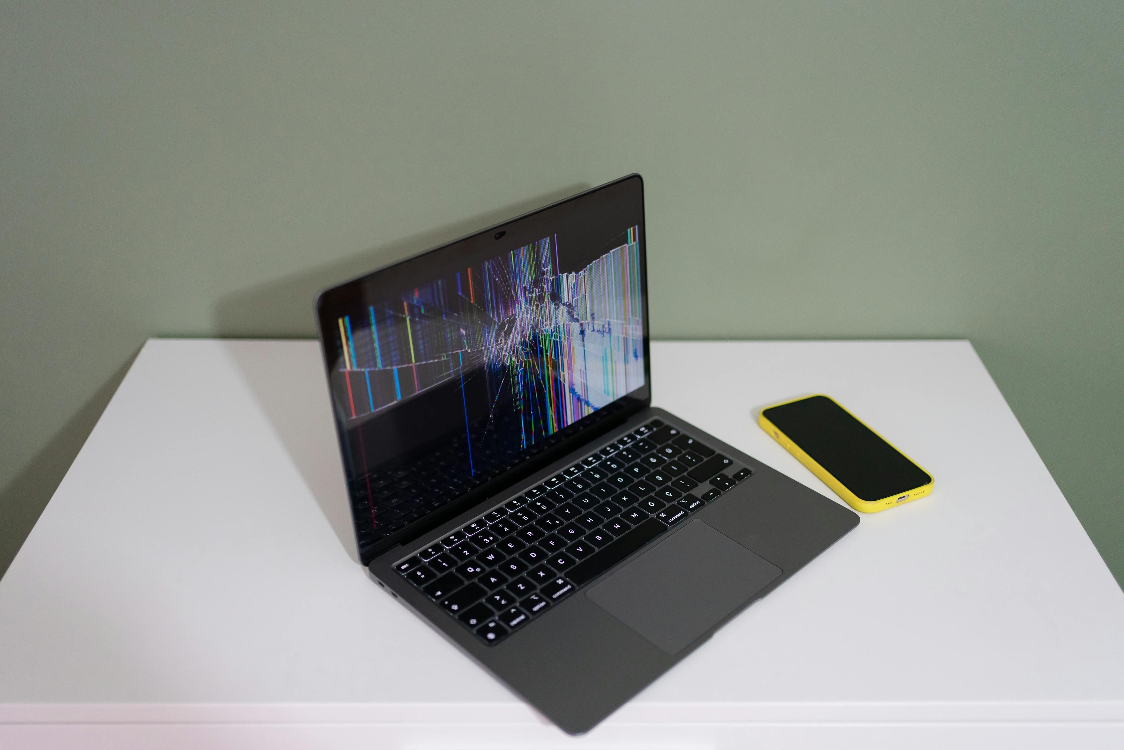 Computer repair workshop — a laptop and a desktop in progress