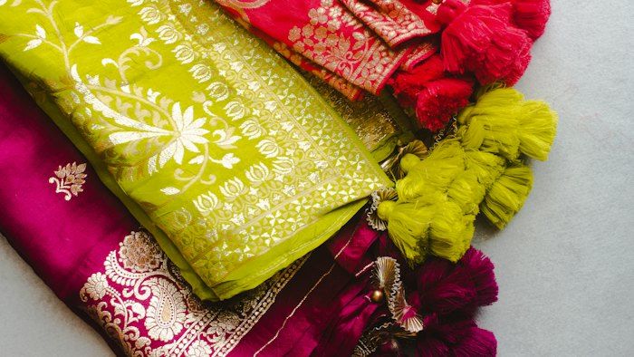 Colourful folded silk sarees arranged together