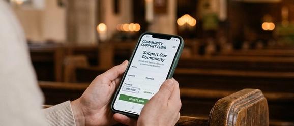 Church leader planning a digital giving strategy on a tablet with giving analytics on screen