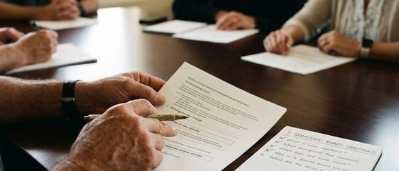 Church board reviewing a technology purchase proposal with critical questions
