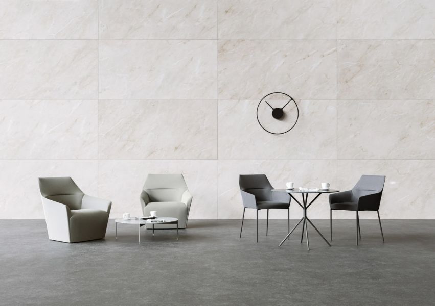 Minimalistické sedenie Chic s dvoma kreslami, stolíkmi a nástennými hodinami v elegantnom interiéri