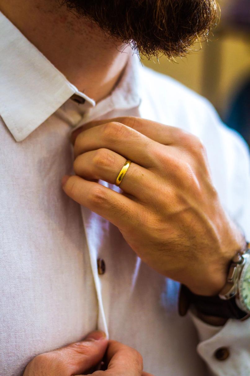 Man applying cologne before a nice dinner date night grooming routine