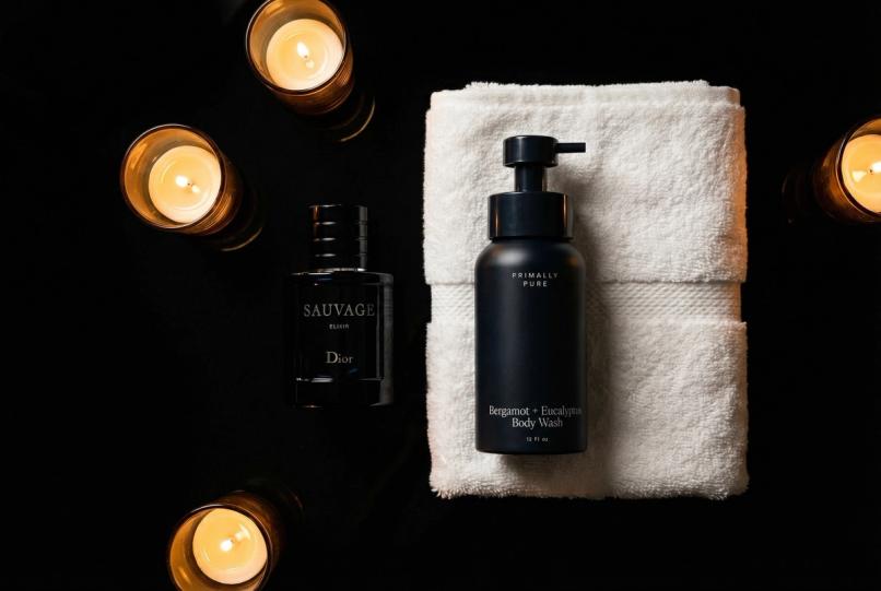 Collection of luxury colognes associated with various celebrities arranged on a marble vanity