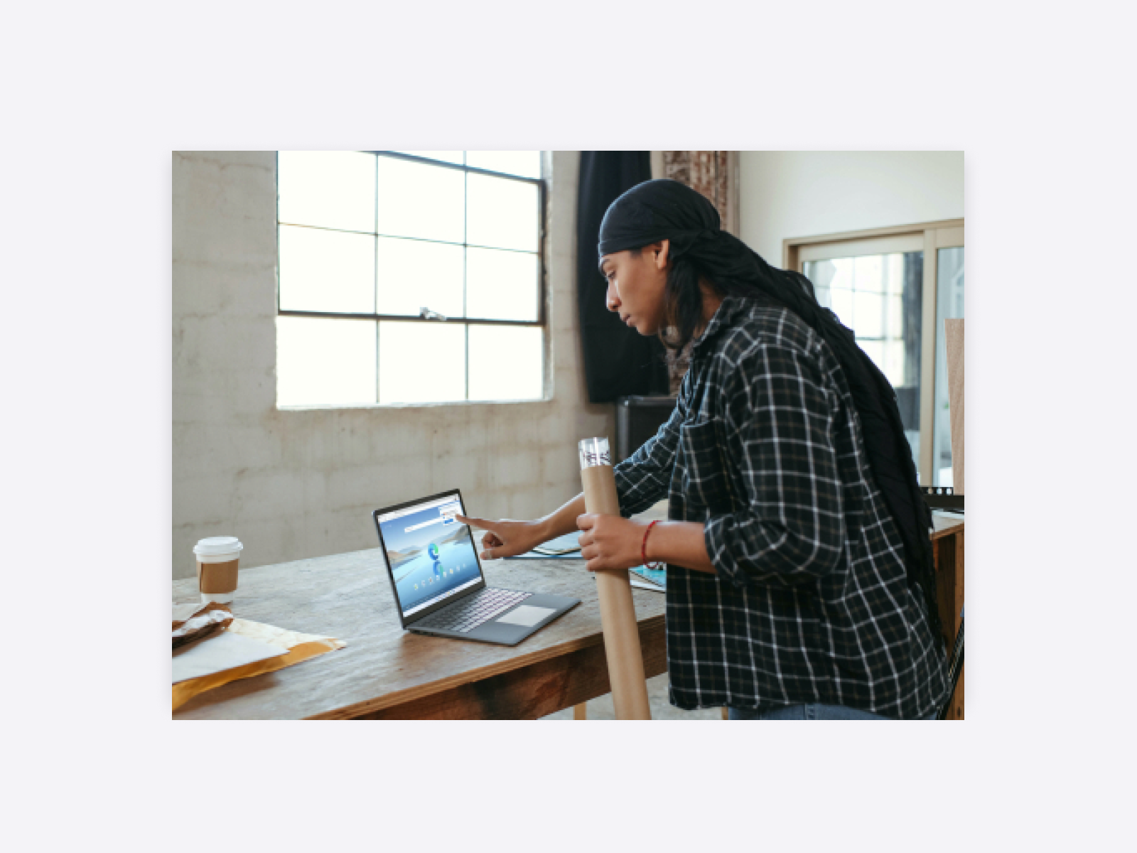 Photo of an art director consulting pointing at their laptop while at work.