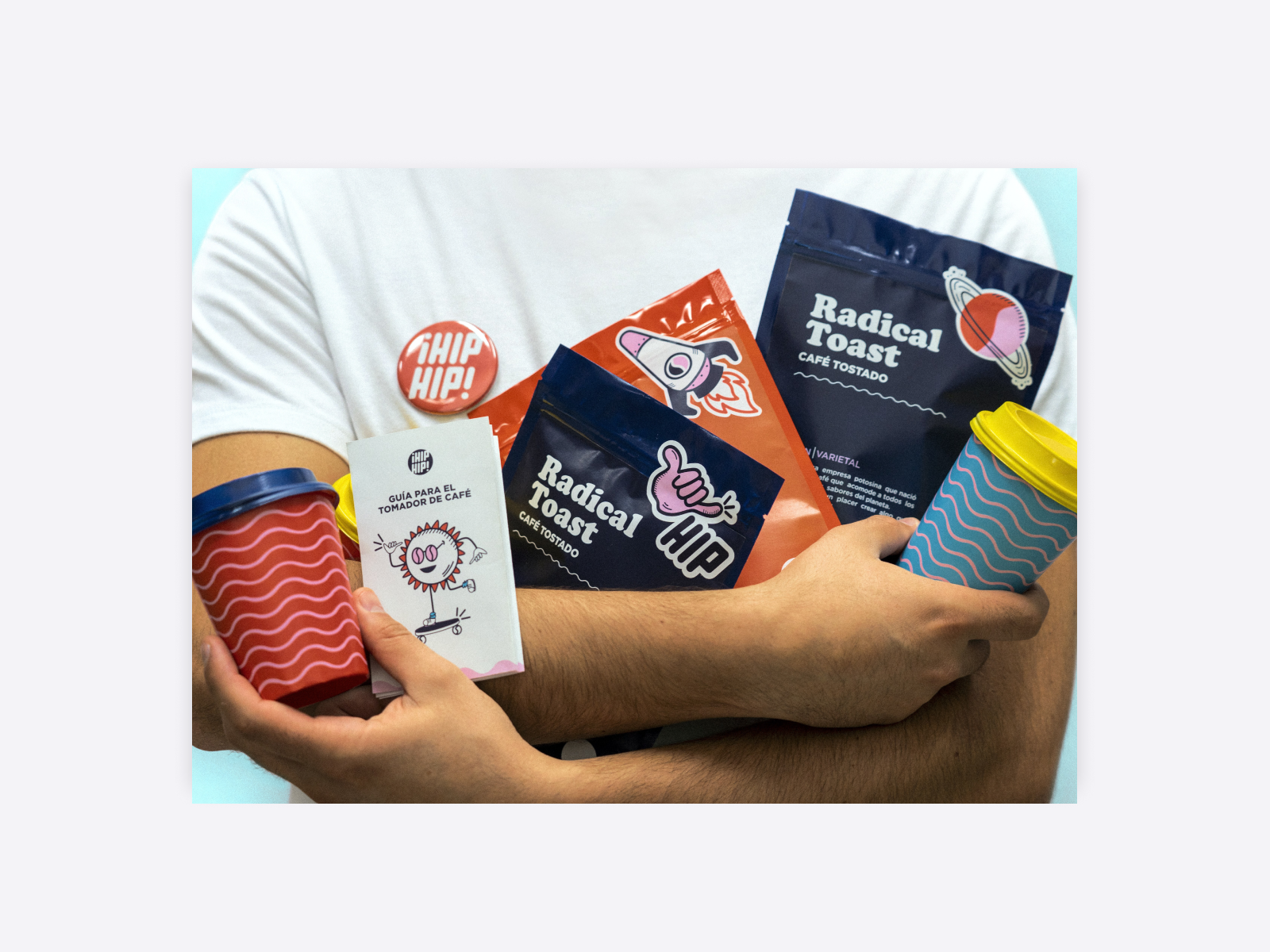 A man holding various products, including cups and packs of toast. Every package has a bright and playful design.